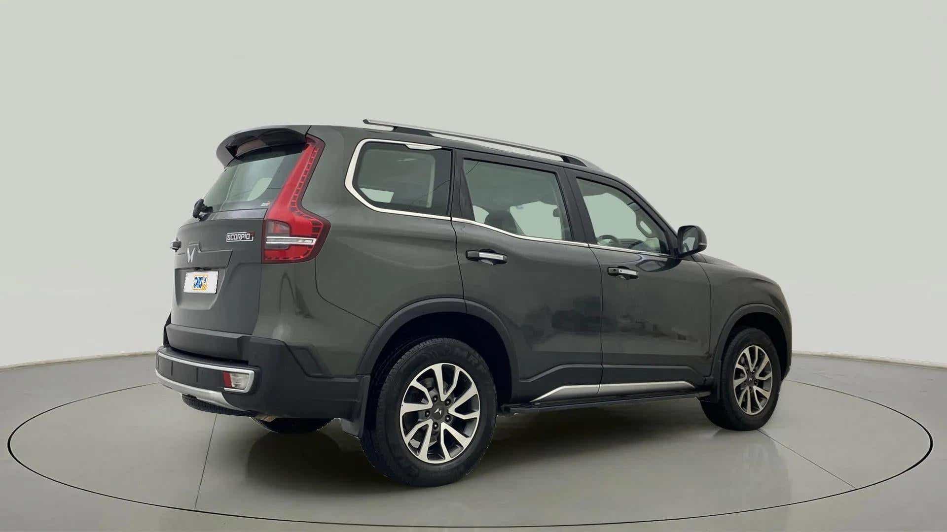 Rear three-quarter view of a deep forest Mahindra Scorpio-N