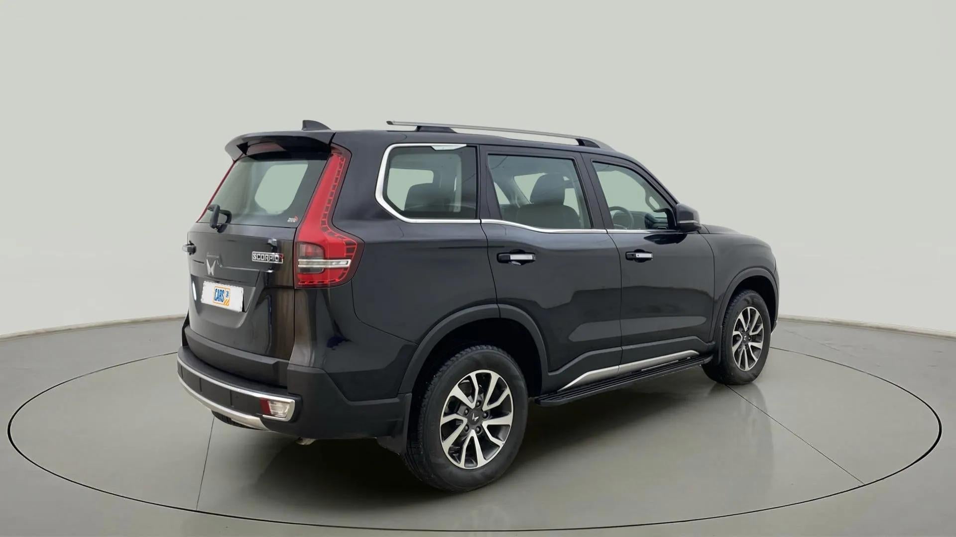 Rear three-quarter view of a deep forest Mahindra Scorpio-N