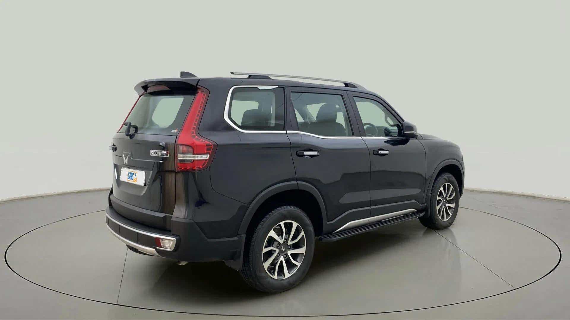 Rear three-quarter view of a deep forest Mahindra Scorpio-N