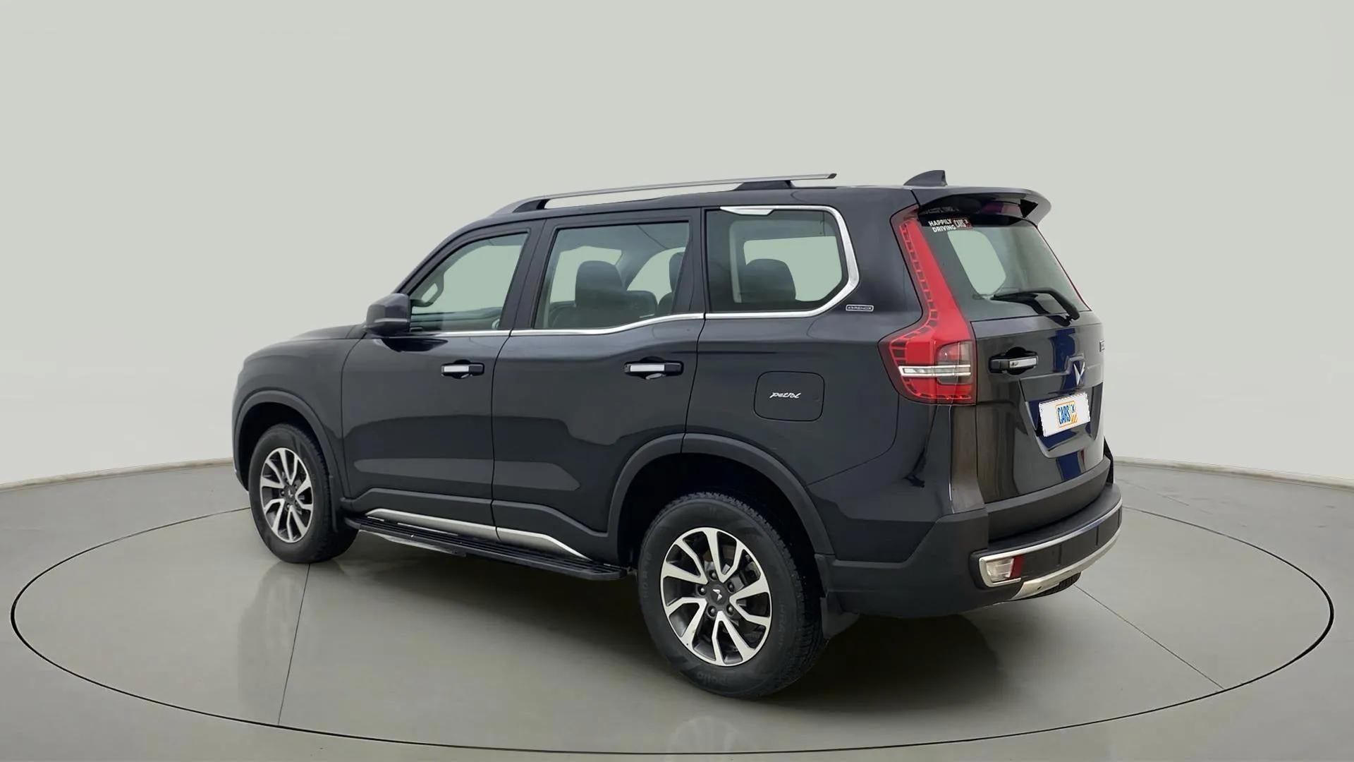 Rear three-quarter view of a deep forest Mahindra Scorpio-N