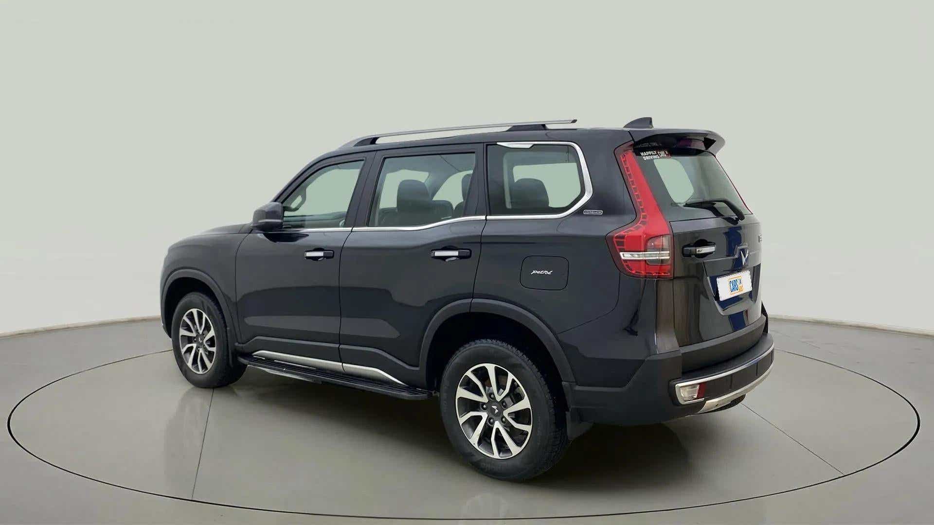 Rear three-quarter view of a deep forest Mahindra Scorpio-N
