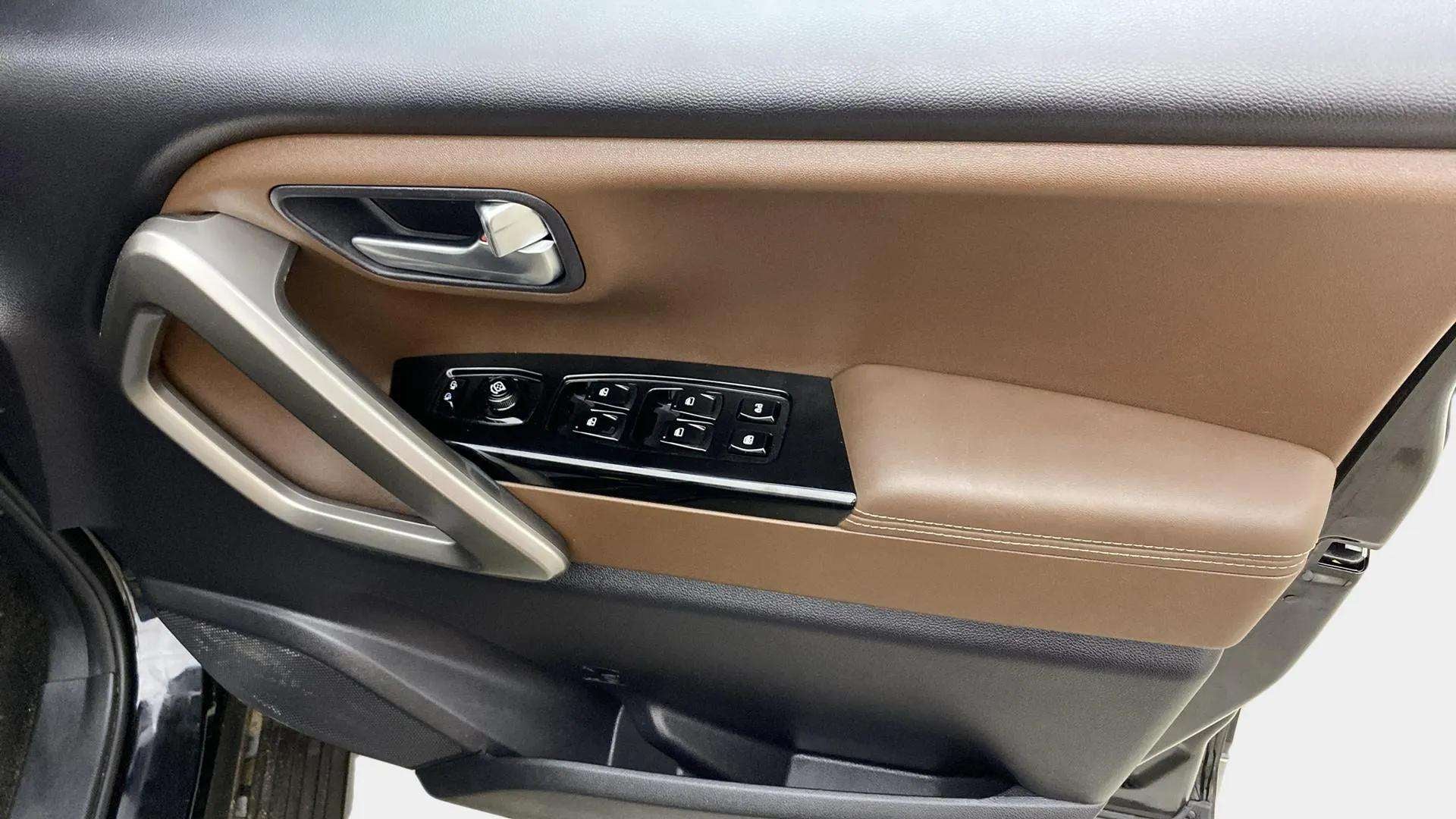 Driver door panel and controls of a Mahindra Scorpio-N