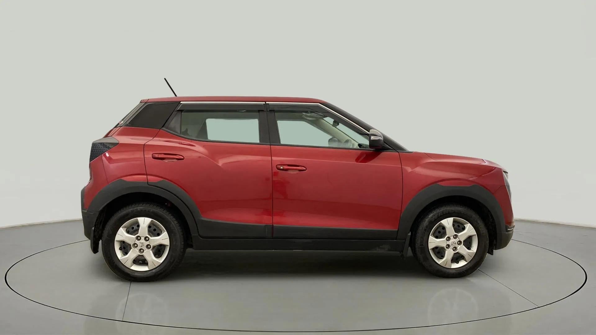 Side view of a tango red with black Mahindra XUV 3XO
