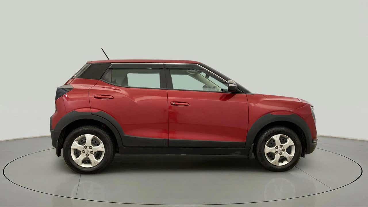 Side view of a tango red with black Mahindra XUV 3XO