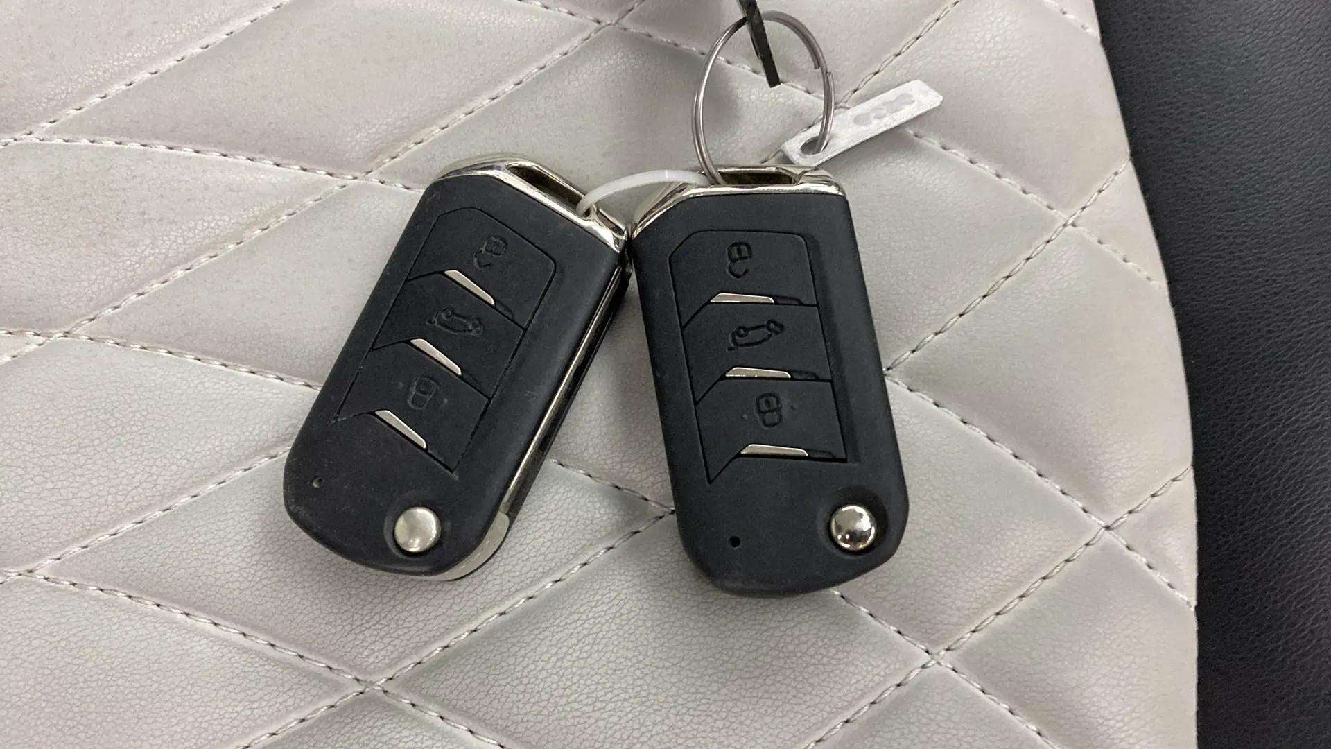 Car key fobs on the seat of a Mahindra XUV 3XO
