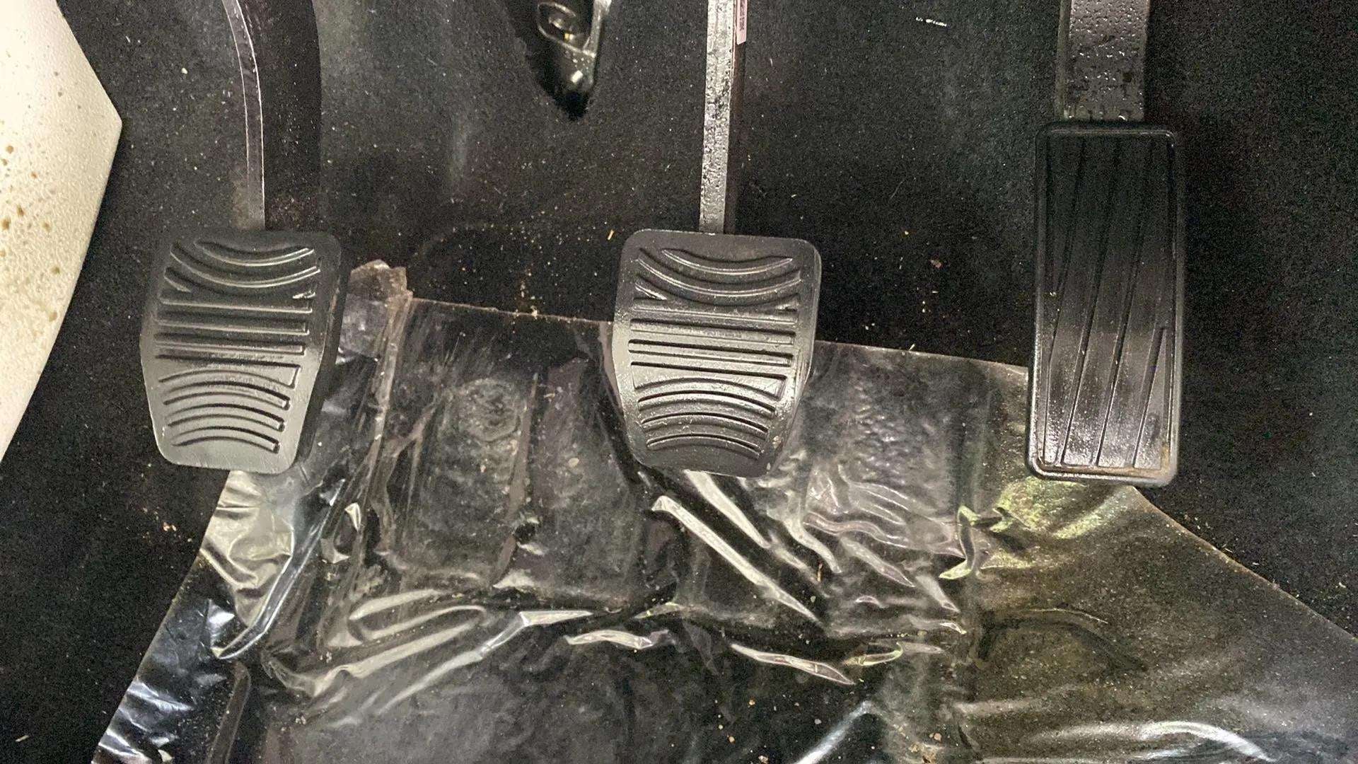 Close-up view of the foot pedals in a Mahindra XUV 3XO
