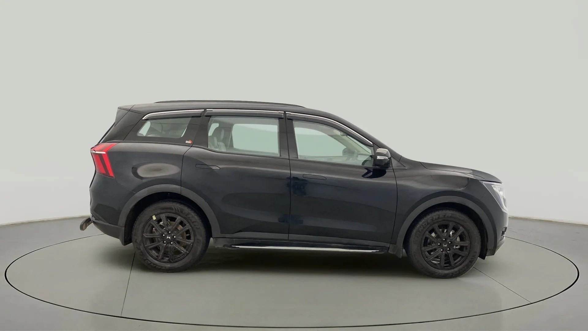 Side profile of a midnight black Mahindra XUV700