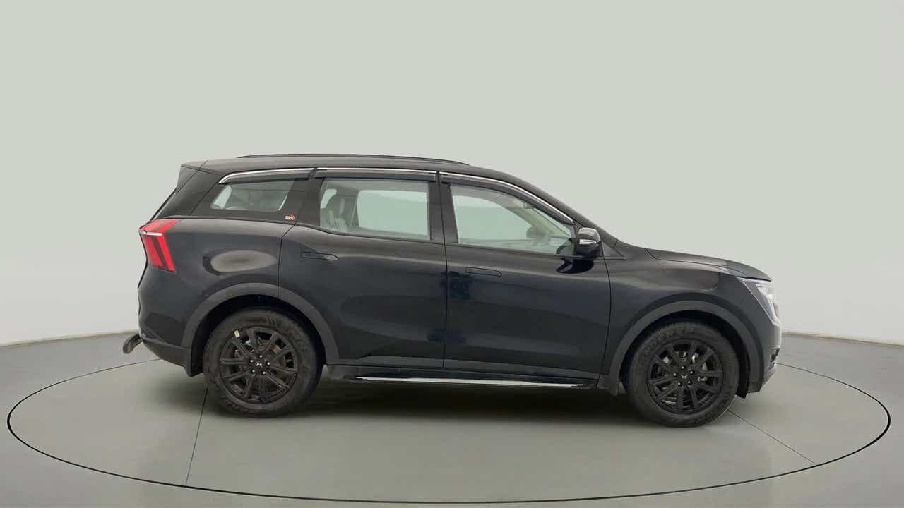 Side profile of a midnight black Mahindra XUV700