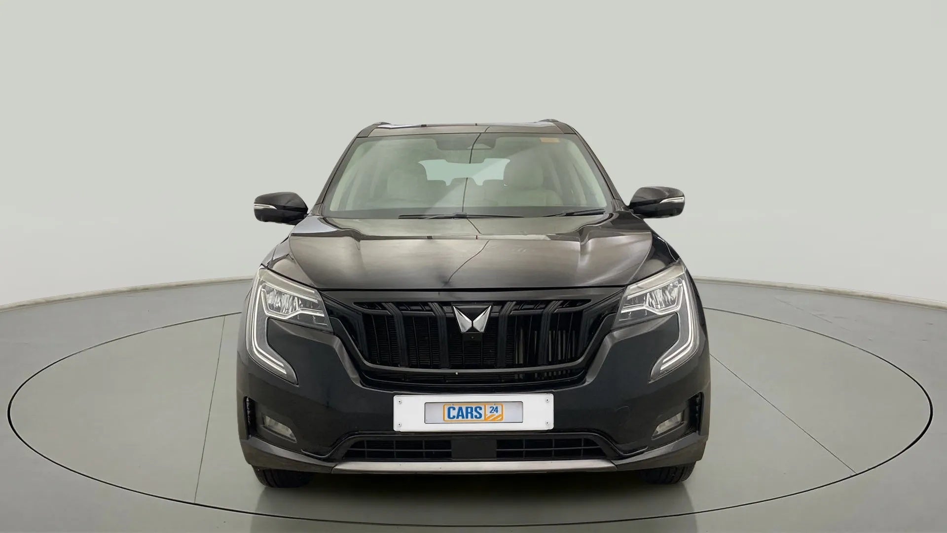 Front view of a midnight black Mahindra XUV700