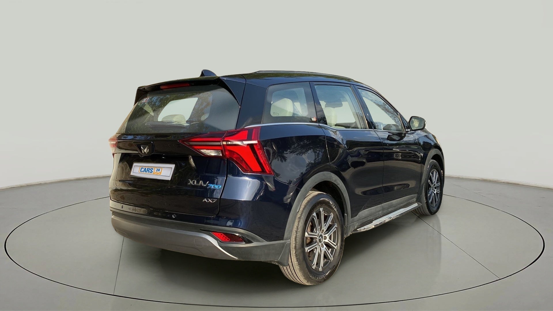Rear three-quarter of a Mahindra XUV700 AX7
