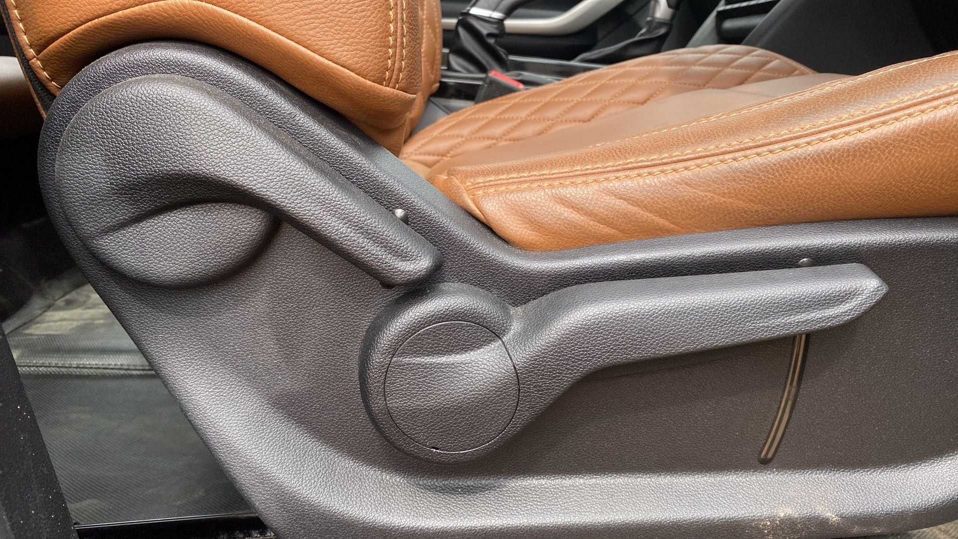 Side view of a Mahindra XUV700 seat adjustment lever