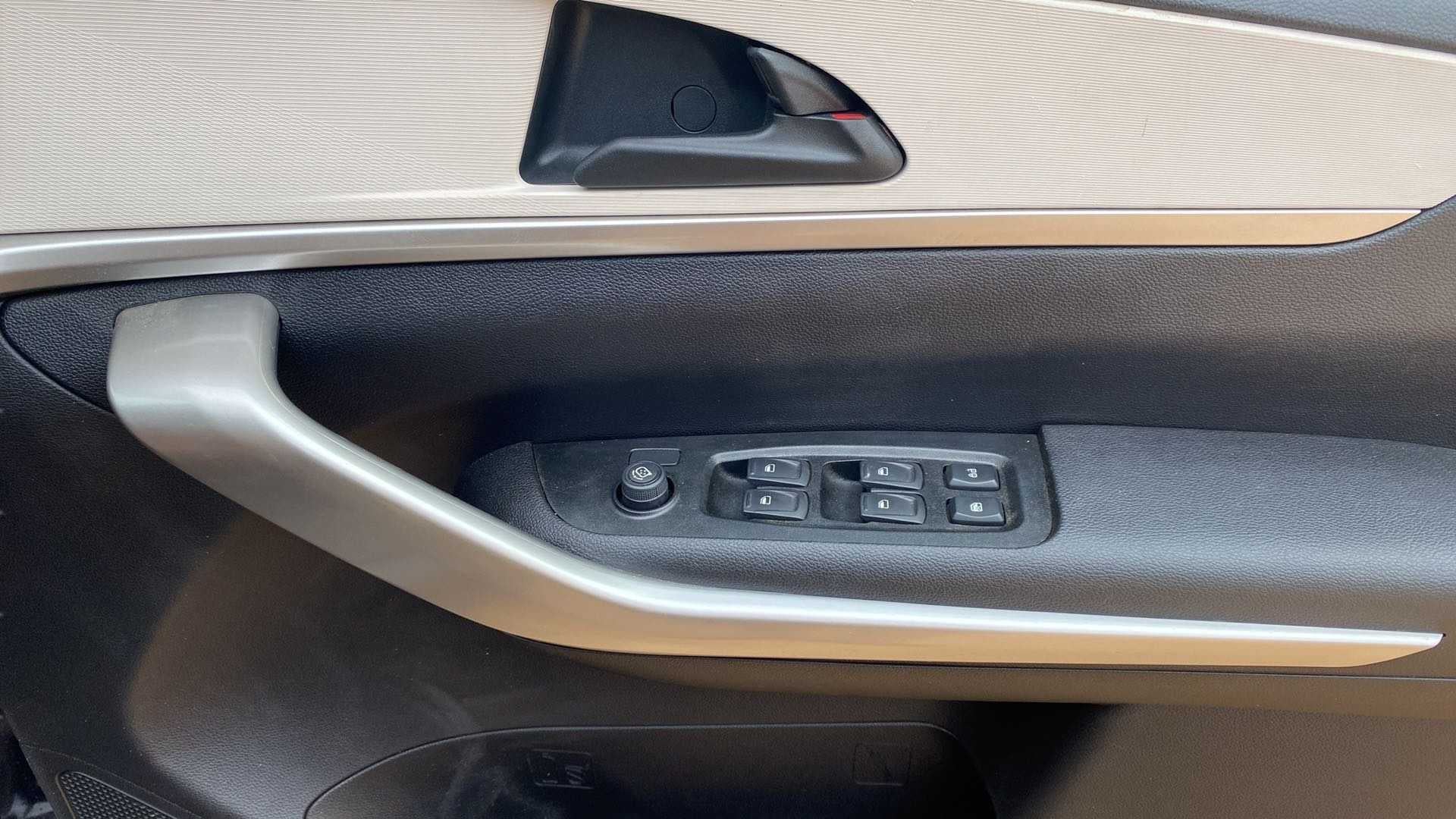 Interior driver-side door controls of a Mahindra XUV700