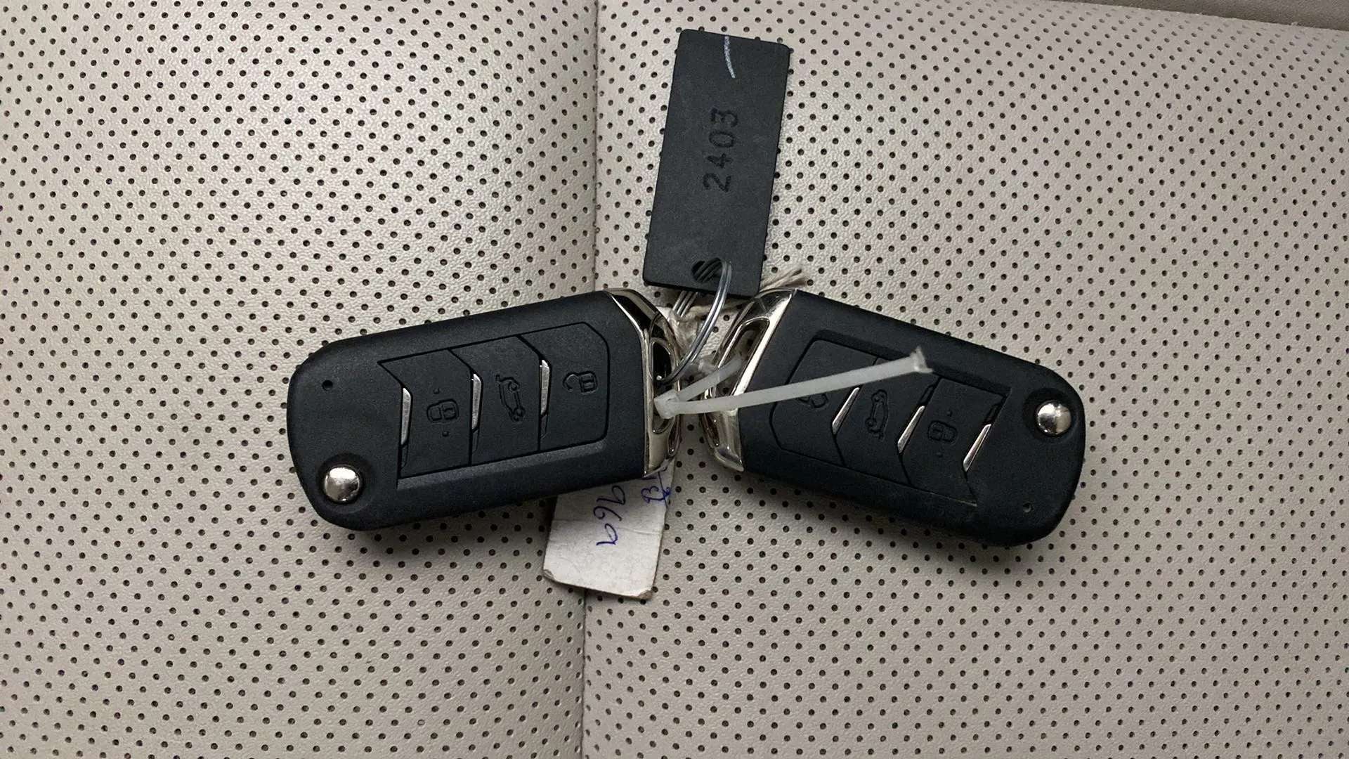 Car key fobs on perforated seat of a Mahindra XUV700