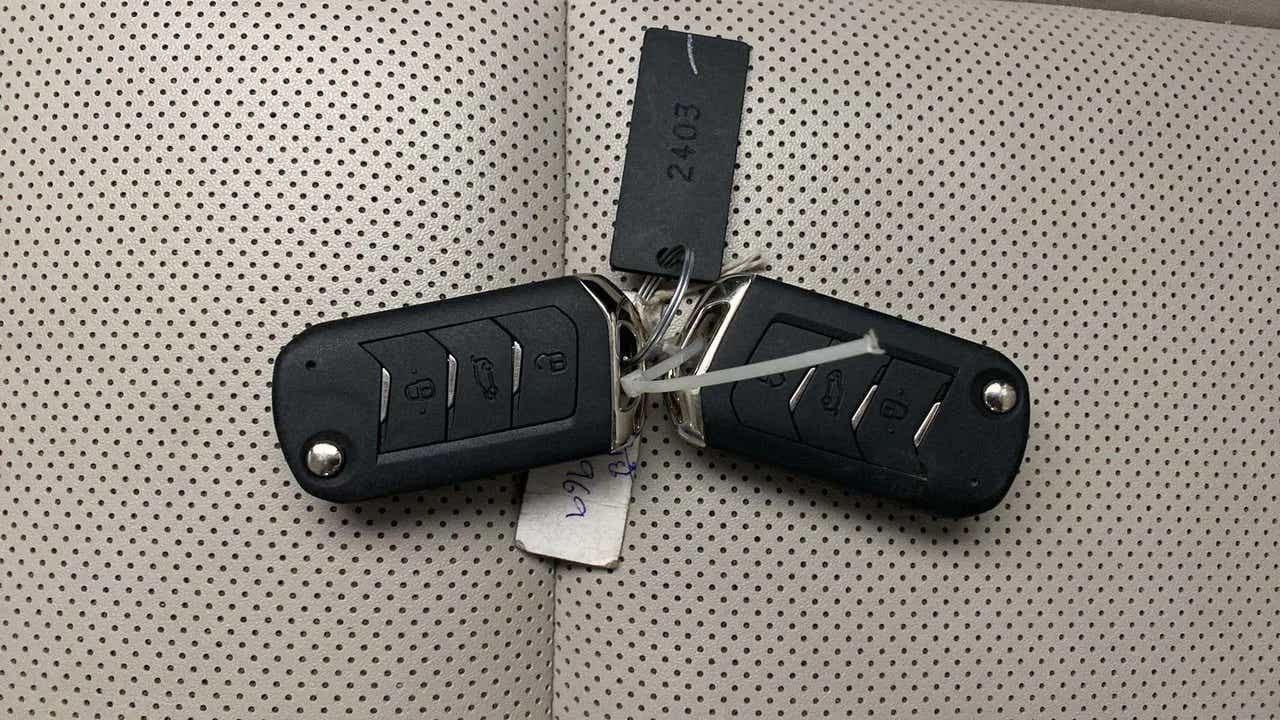 Car key fobs on perforated seat of a Mahindra XUV700