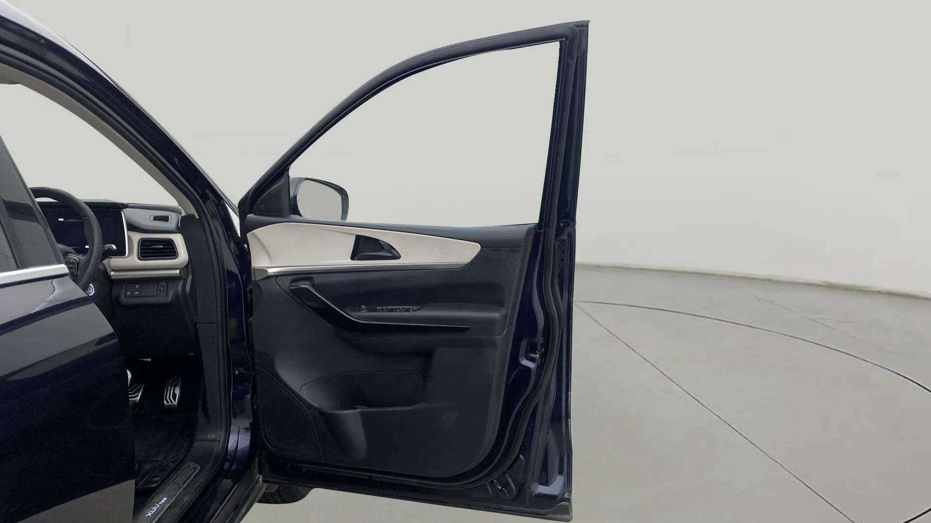 Driver door and dashboard view of a Mahindra XUV700