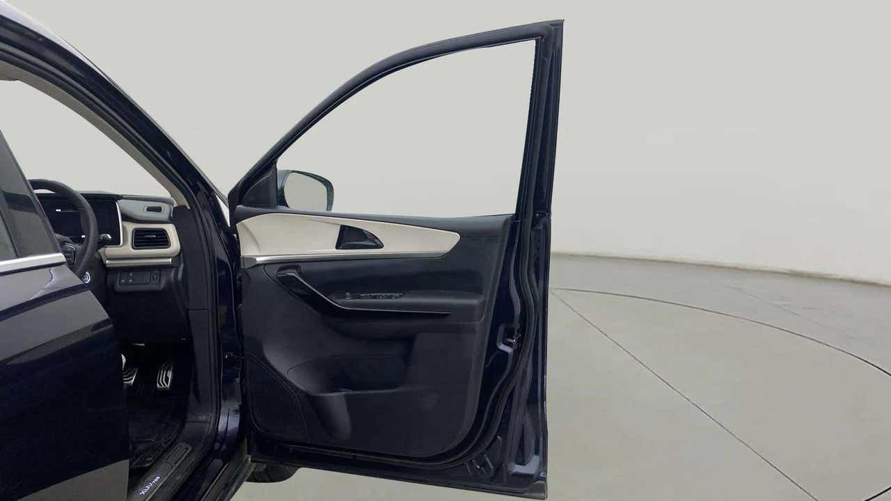 Driver door and dashboard view of a Mahindra XUV700