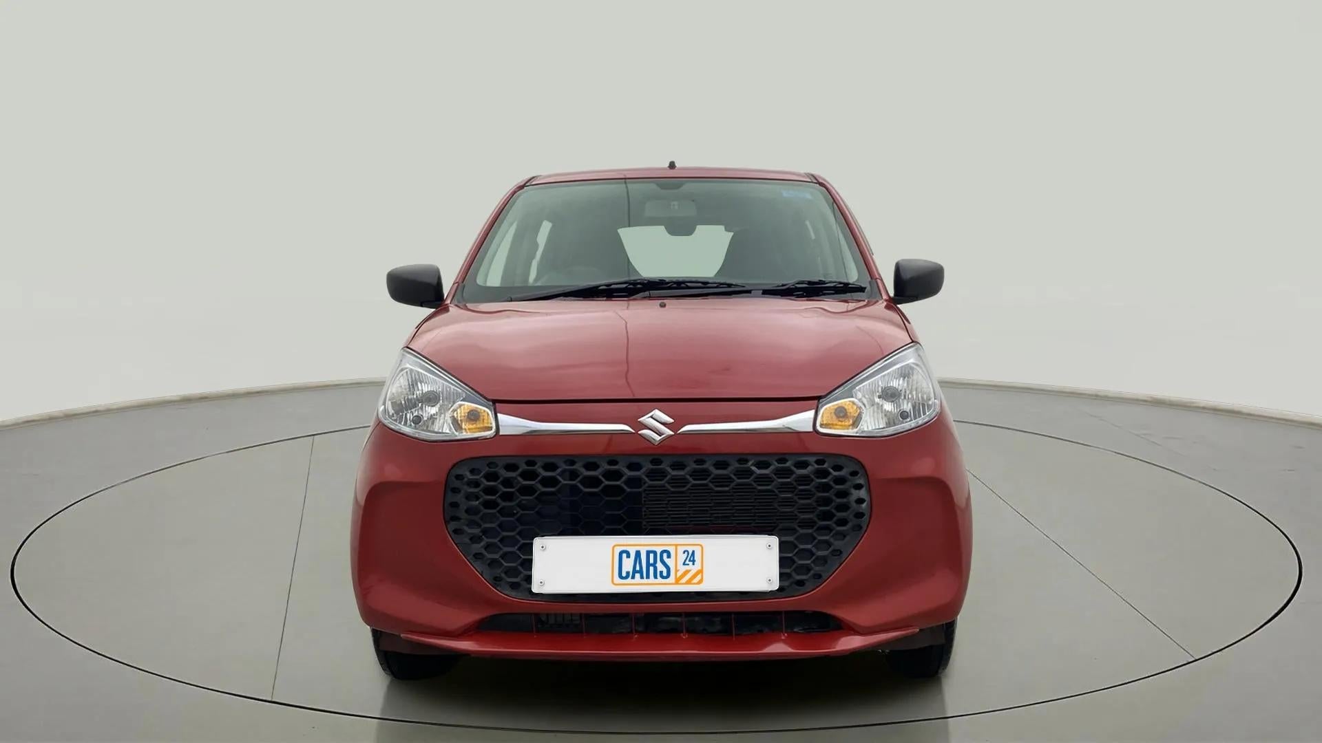 Front view of a Metallic Sizzling Red Maruti Suzuki Alto K10