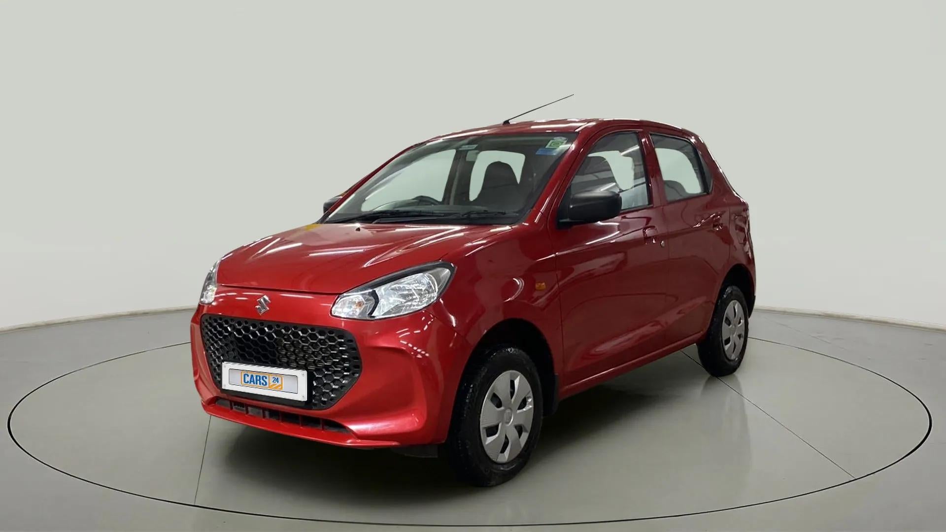 Front three-quarter view of a Metallic Sizzling Red Maruti Suzuki Alto K10