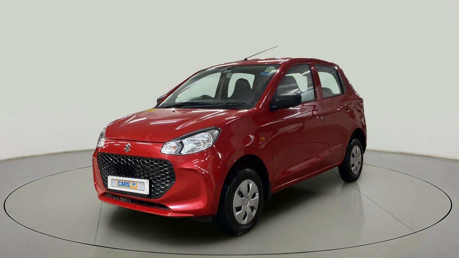 Front three-quarter view of a Metallic Sizzling Red Maruti Suzuki Alto K10