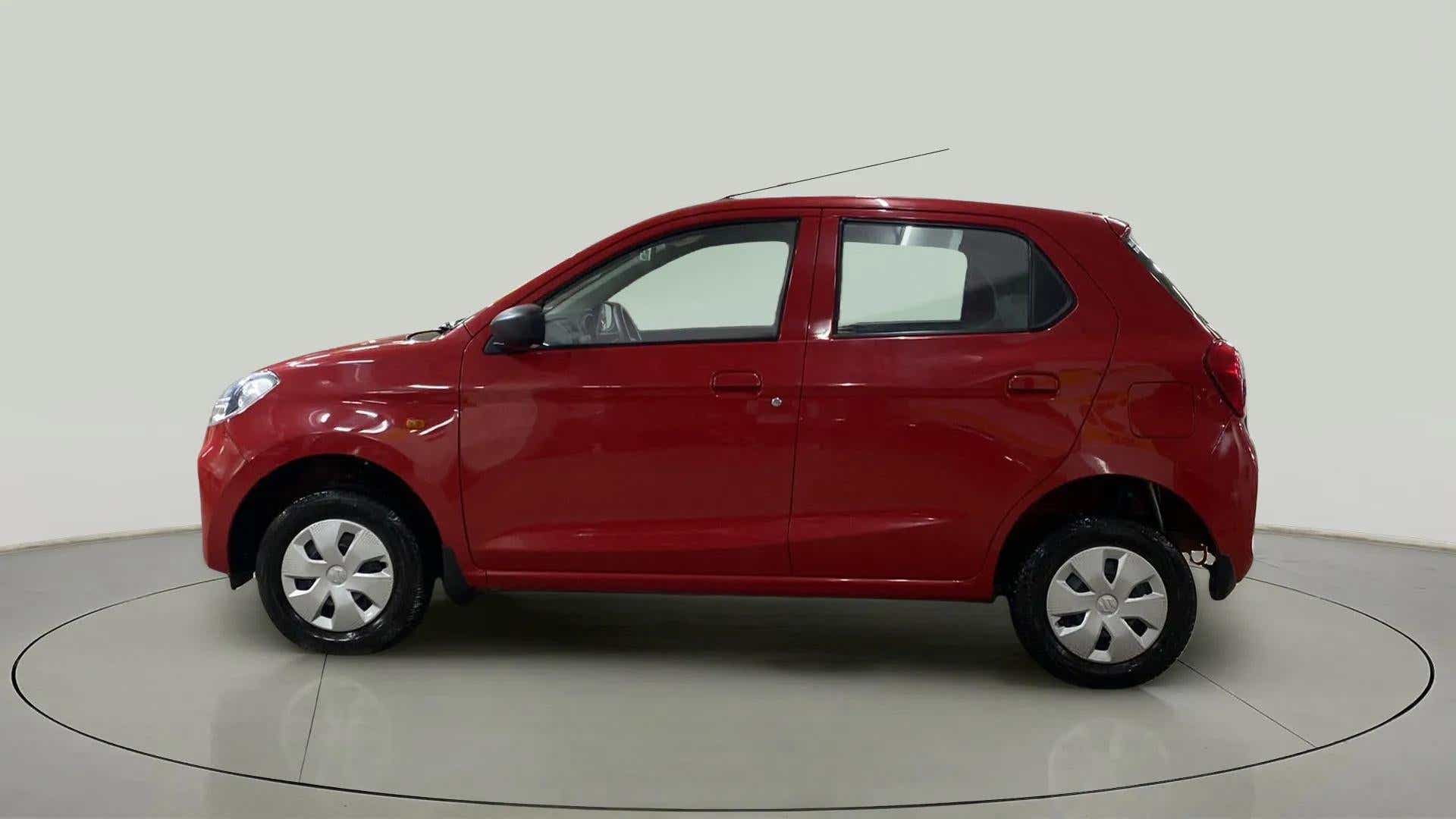 Side view of a metallic sizzling red Maruti Suzuki Alto K10