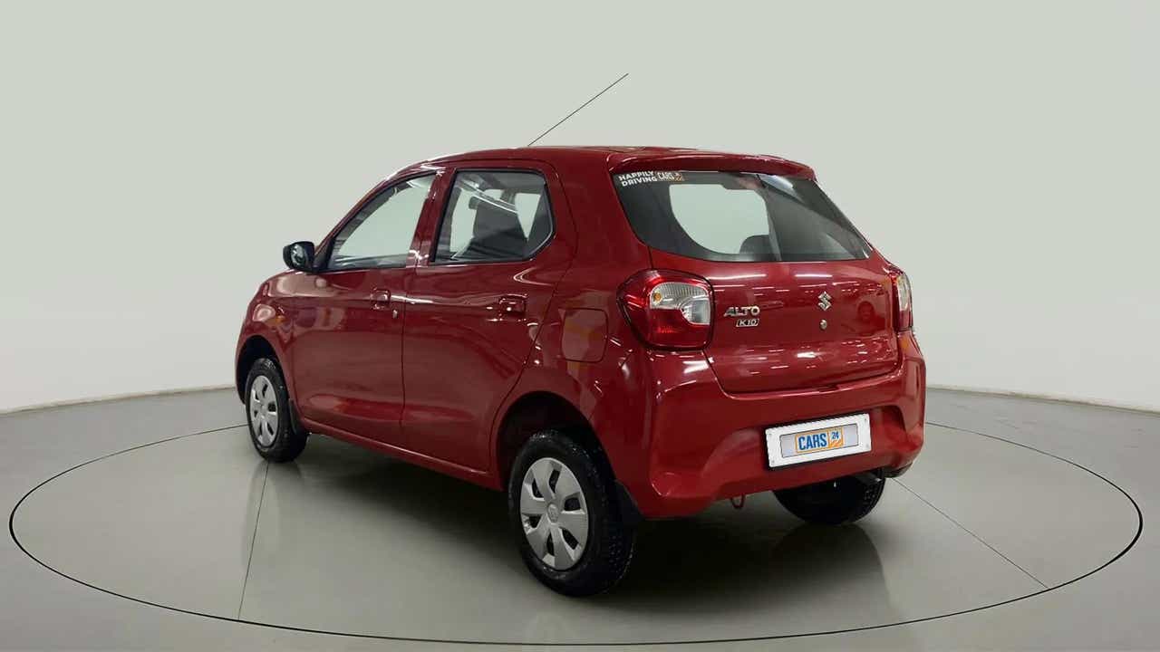 Rear three-quarter view of a metallic sizzling red Maruti Suzuki Alto K10