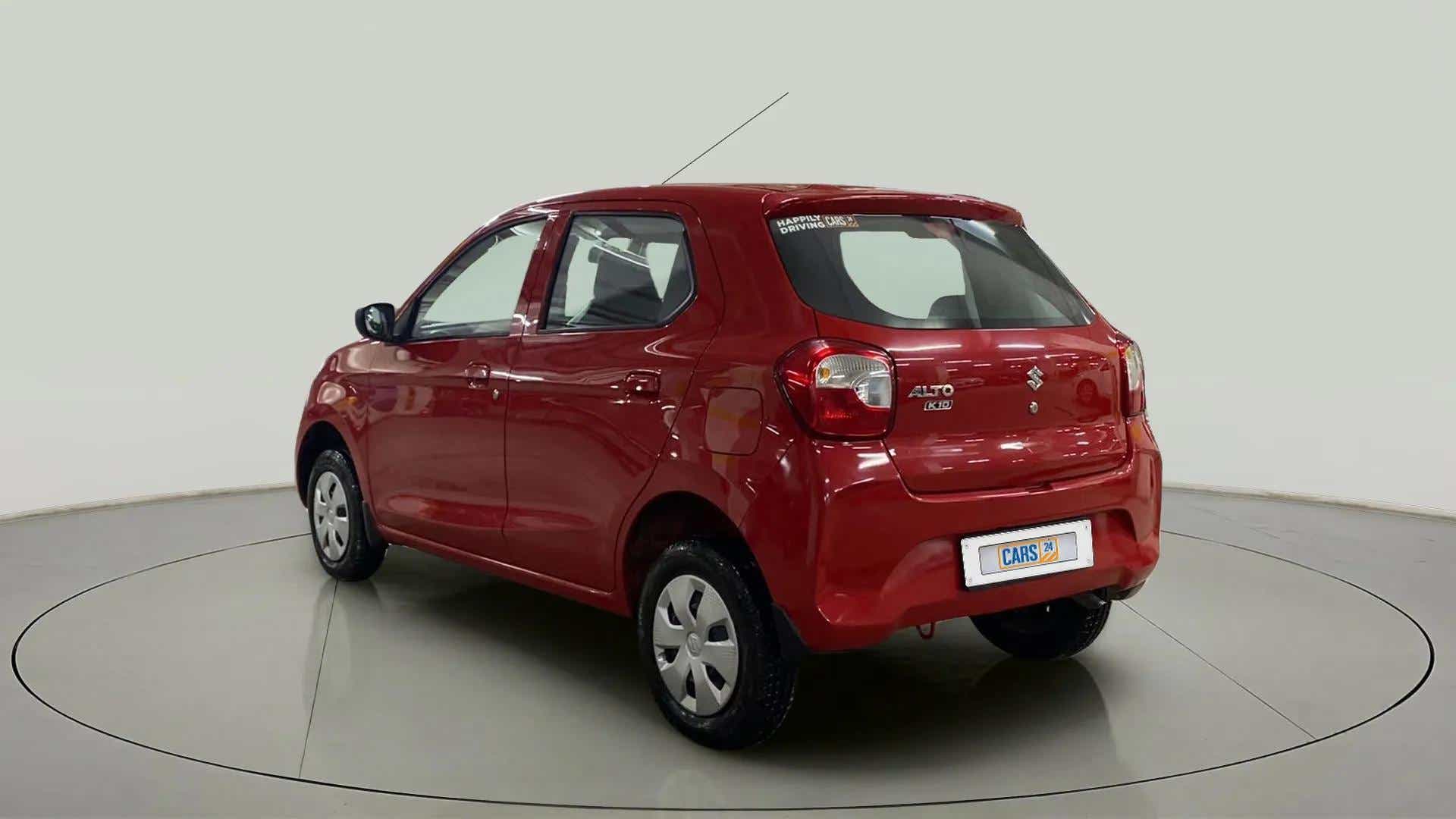 Rear three-quarter view of a metallic sizzling red Maruti Suzuki Alto K10