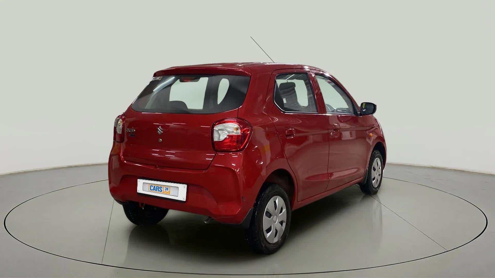 Rear three-quarter view of a metallic-sizzling-red Maruti Suzuki Alto K10
