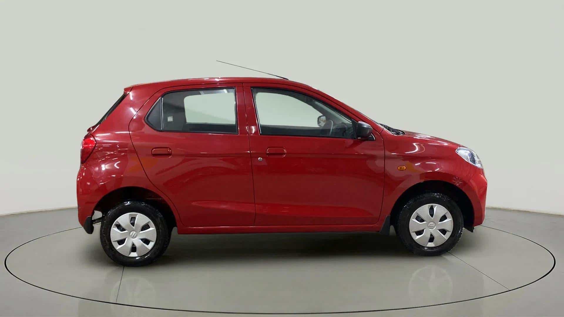 Side view of a Metallic Sizzling Red Maruti Suzuki Alto K10