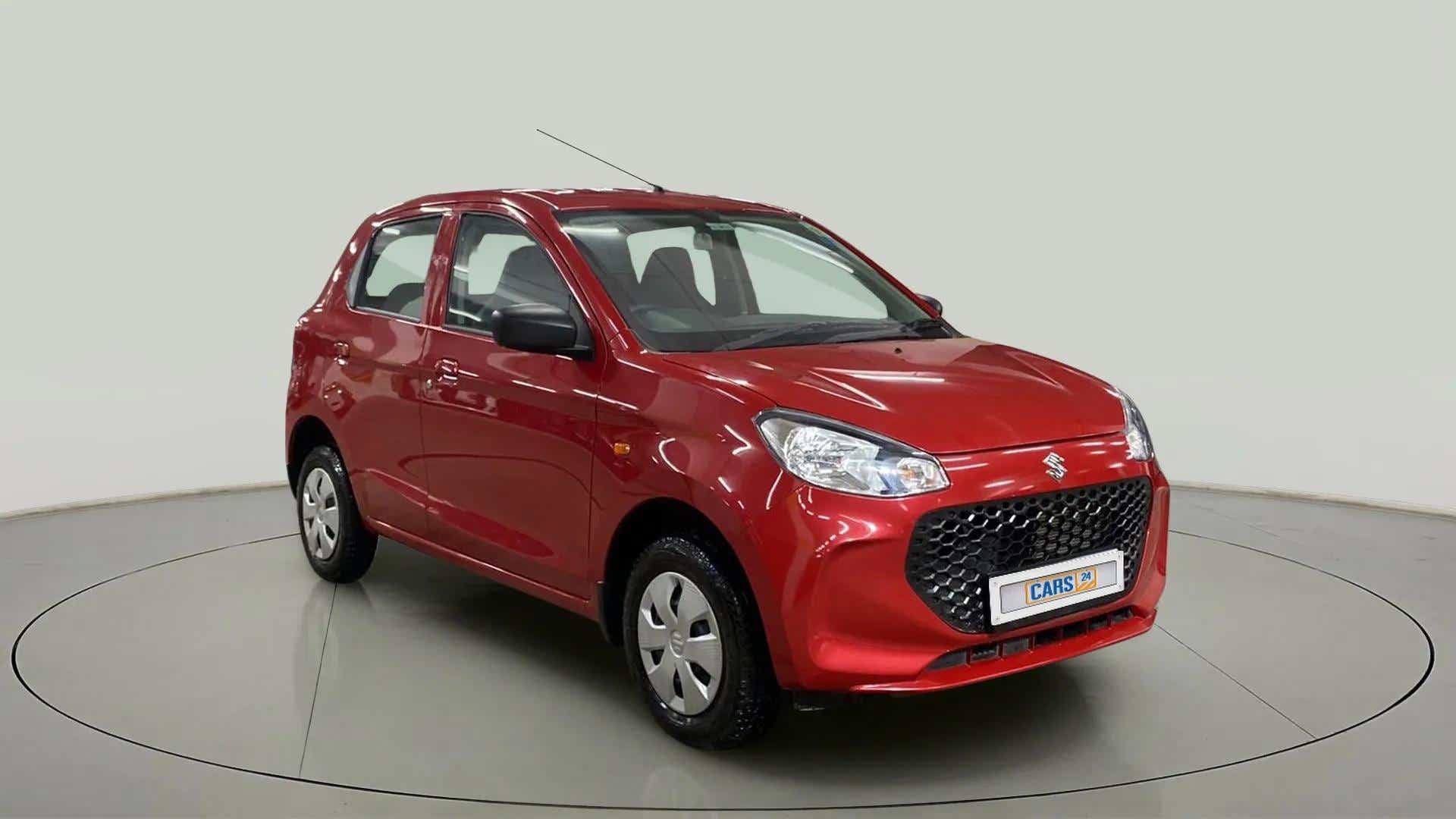 Front three-quarter view of a metallic sizzling red Maruti Suzuki Alto K10