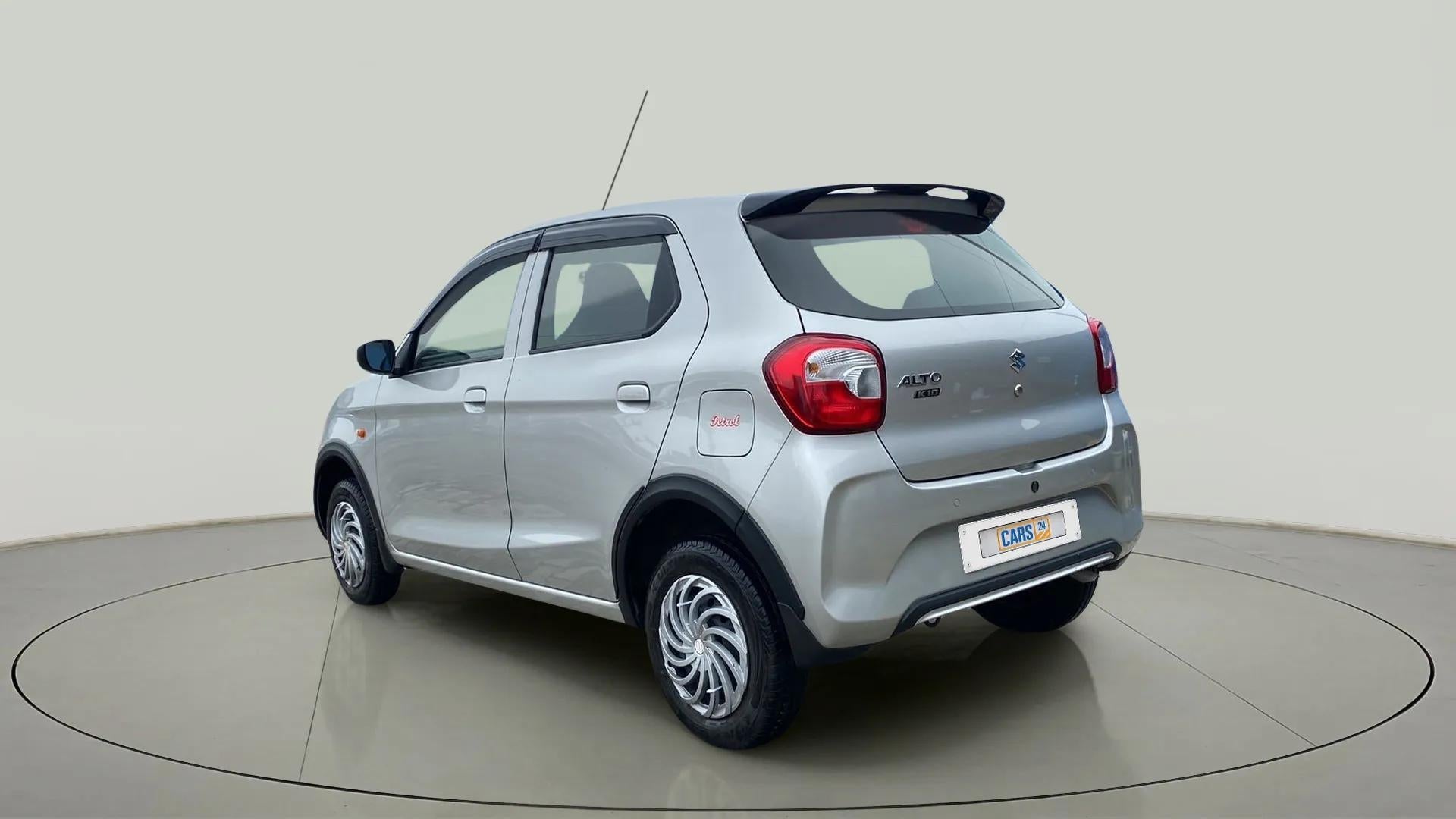 Rear three-quarter of a metallic-silky-silver Maruti Suzuki Alto K10