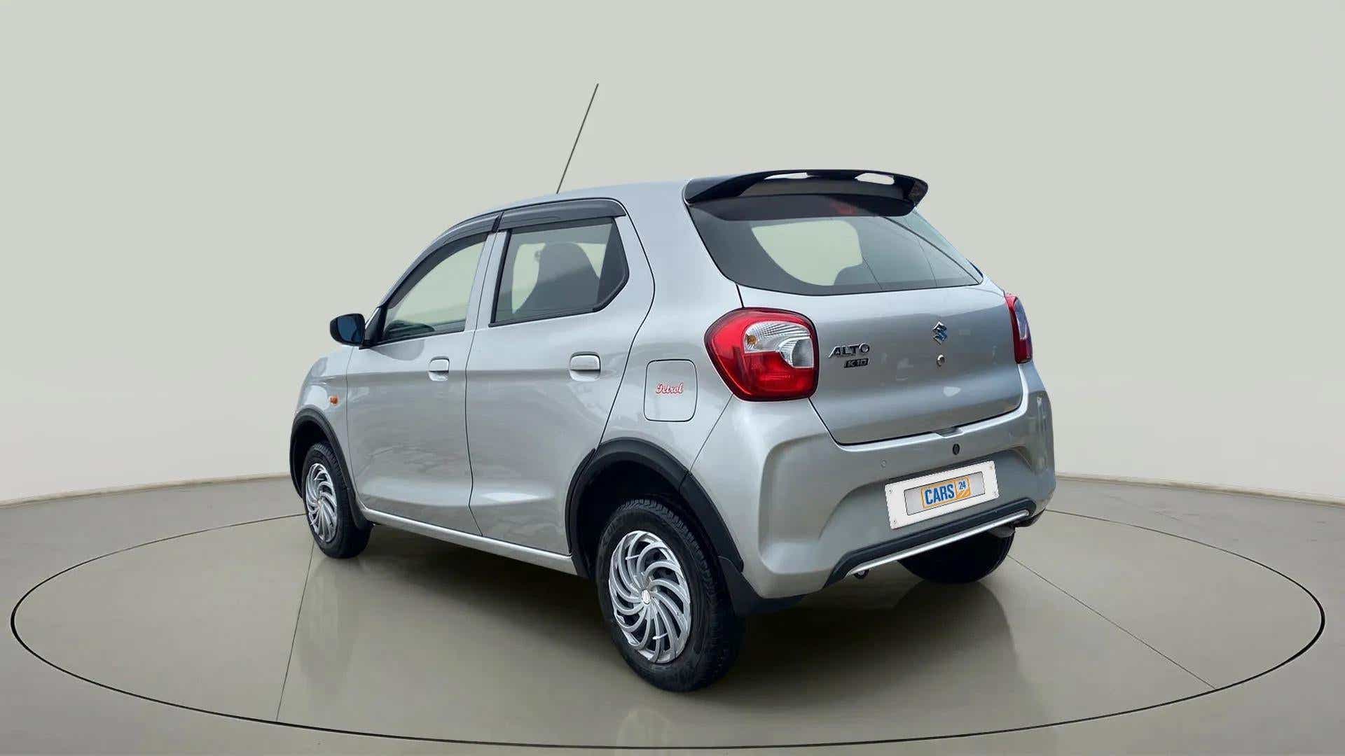 Rear three-quarter of a metallic-silky-silver Maruti Suzuki Alto K10