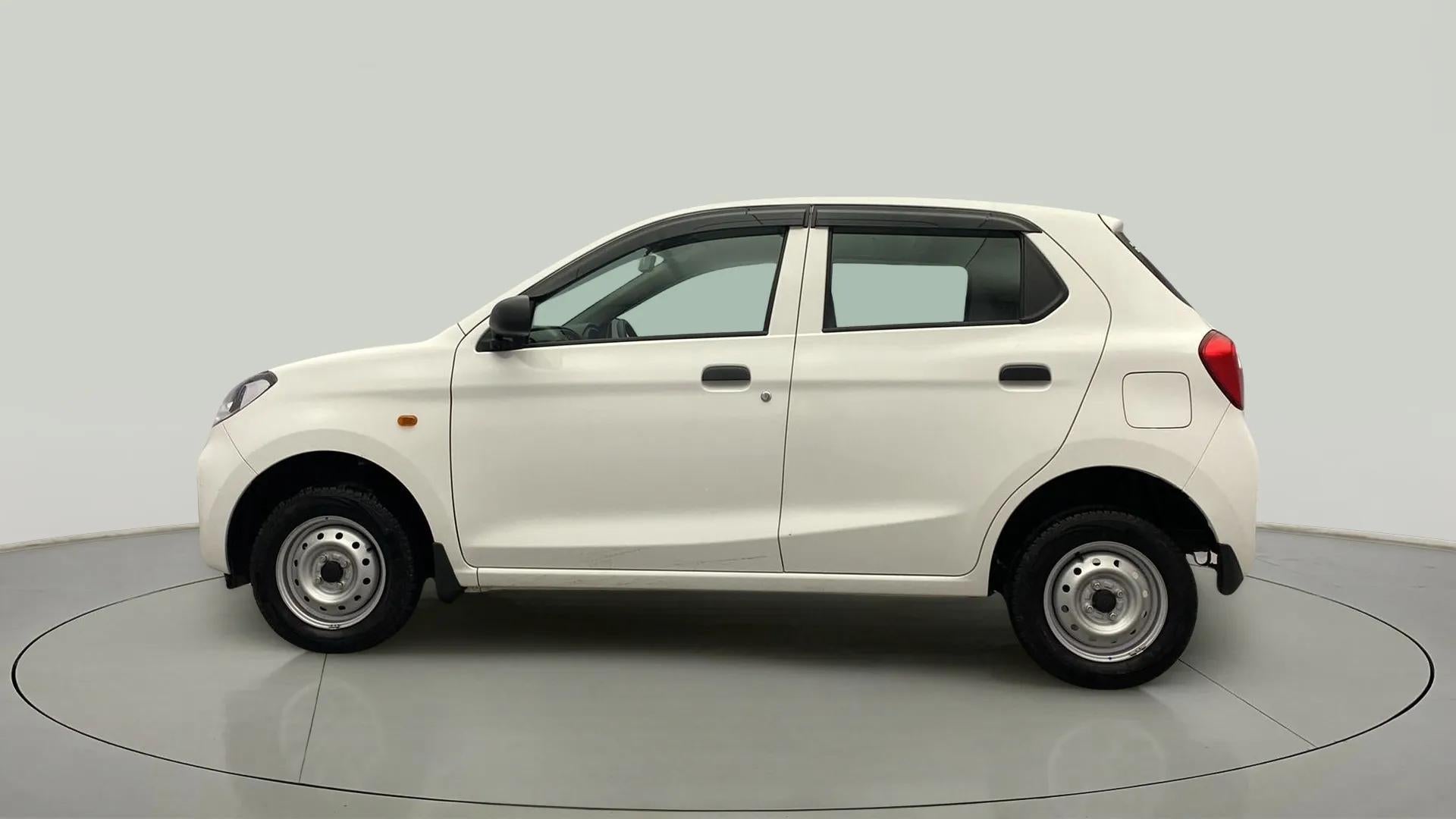 Side view of a metallic solid white Maruti Suzuki Alto K10