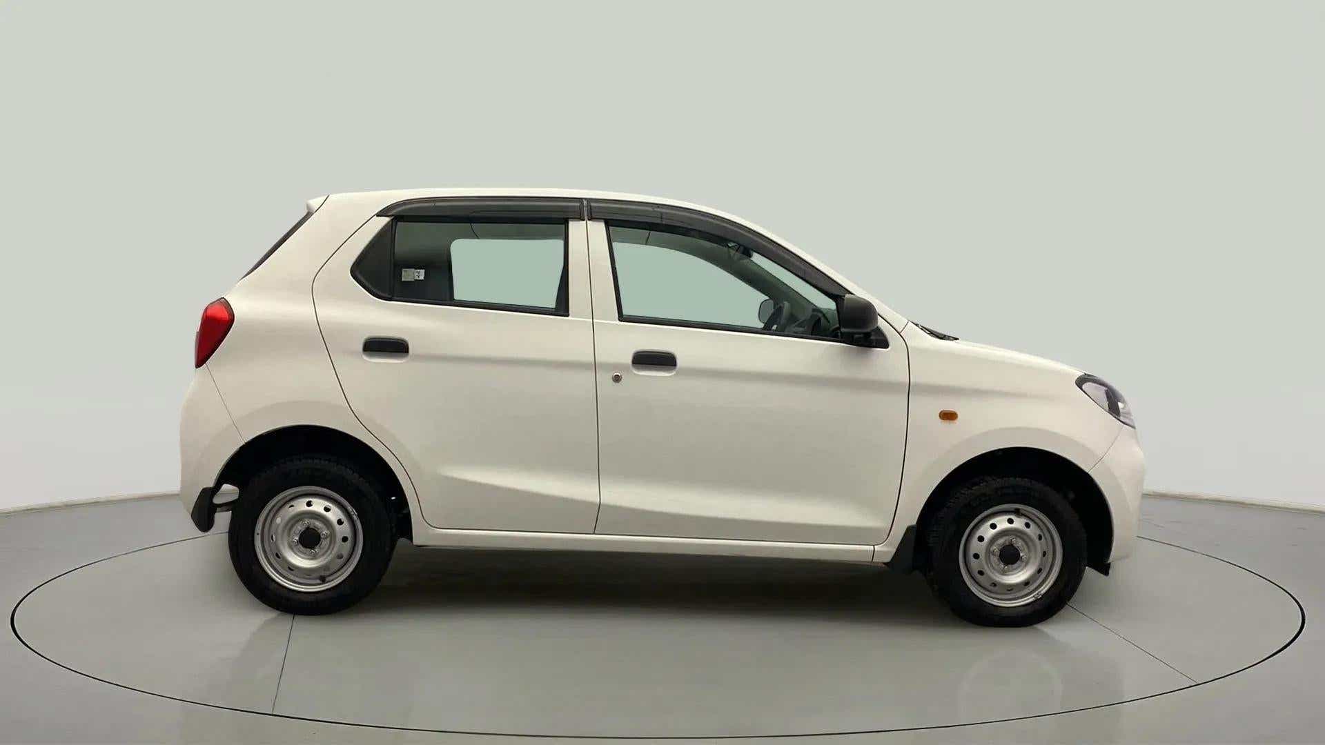 Side view of a metallic solid white Maruti Suzuki Alto K10