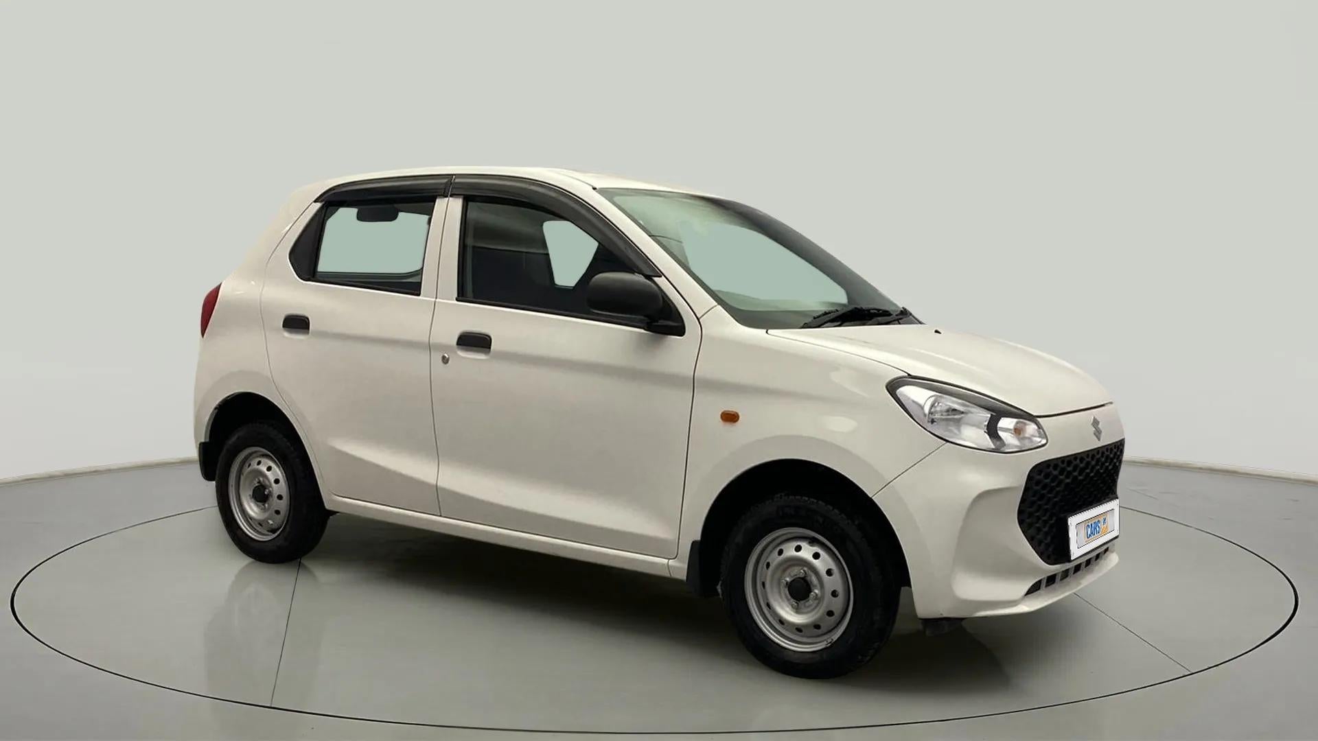 Front side view of a metallic solid white Maruti Suzuki Alto K10