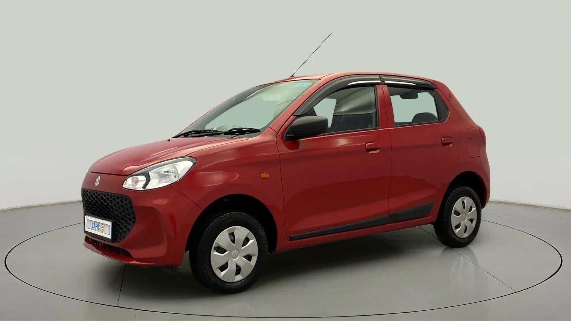 Front three-quarter view of a Metallic Sizzling Red Maruti Suzuki Alto K10