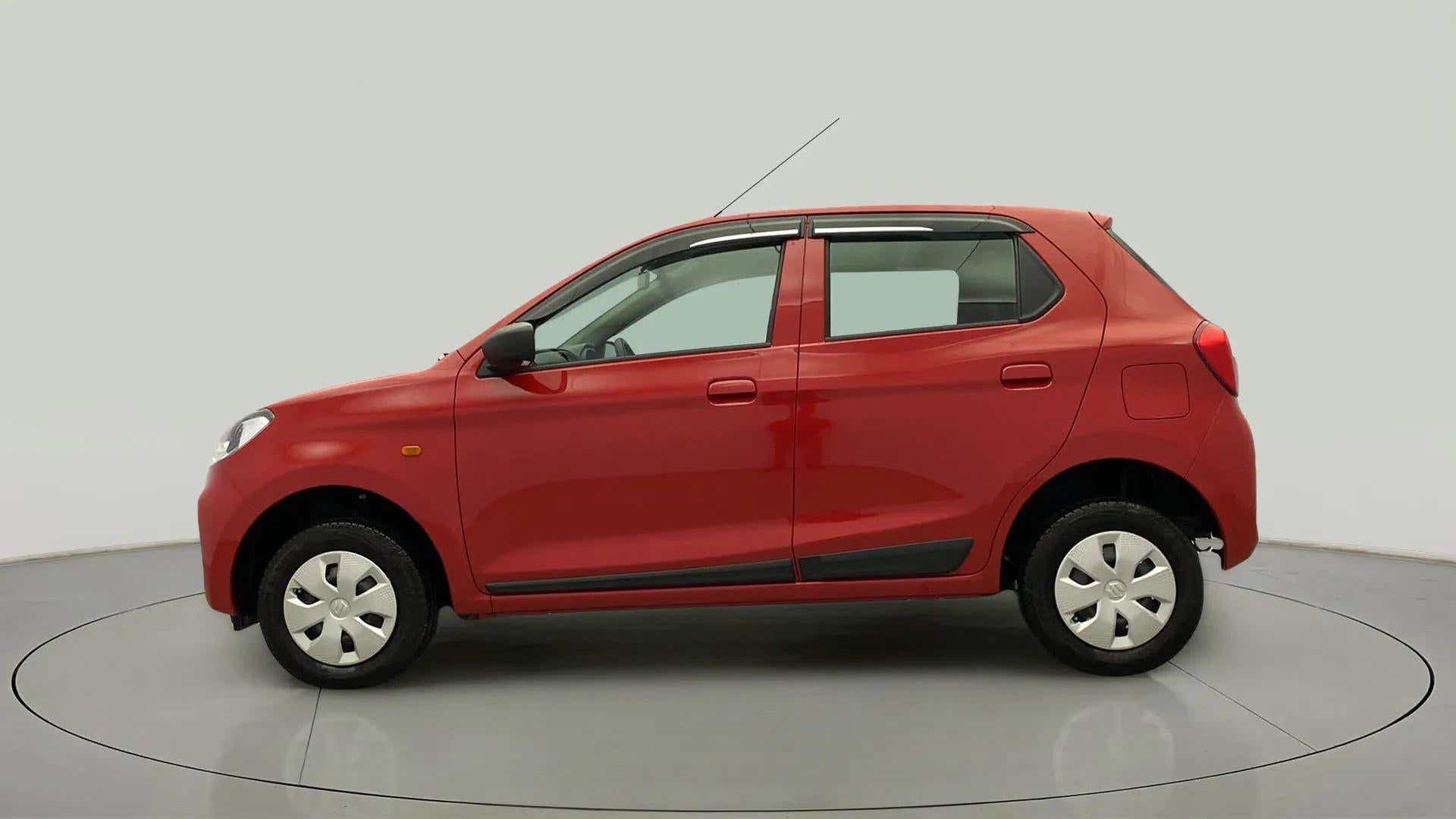 Side view of a metallic sizzling red Maruti Suzuki Alto K10