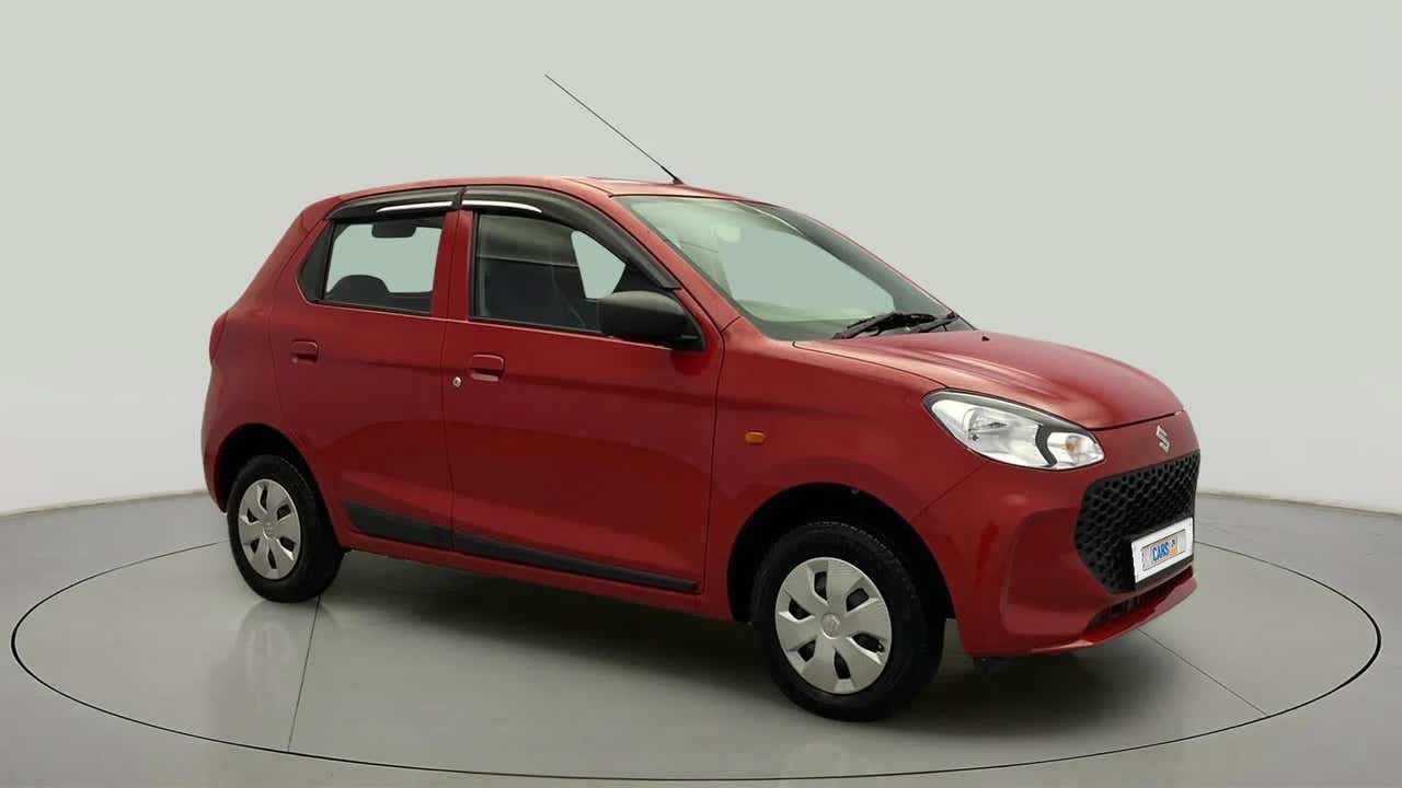 Front three-quarter view of a metallic sizzling red Maruti Suzuki Alto K10