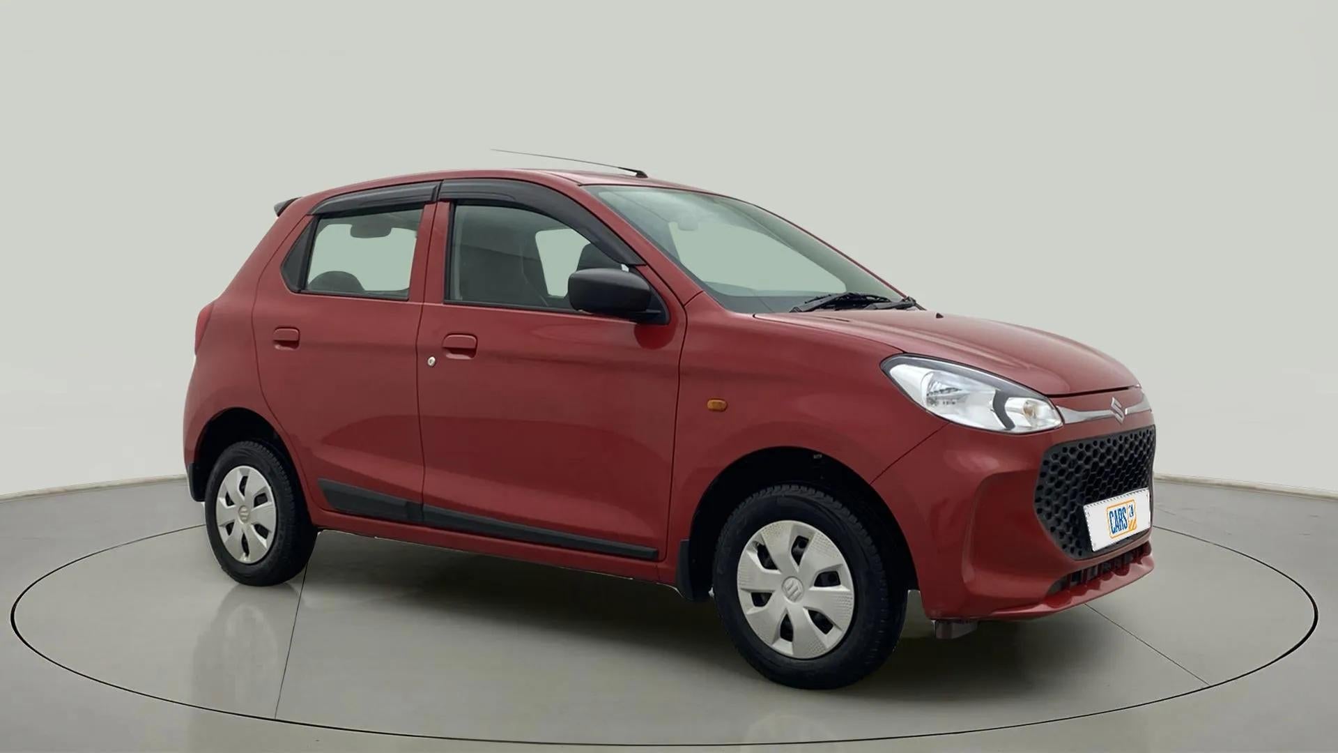 Front three-quarter view of a Metallic Sizzling Red Maruti Suzuki Alto K10