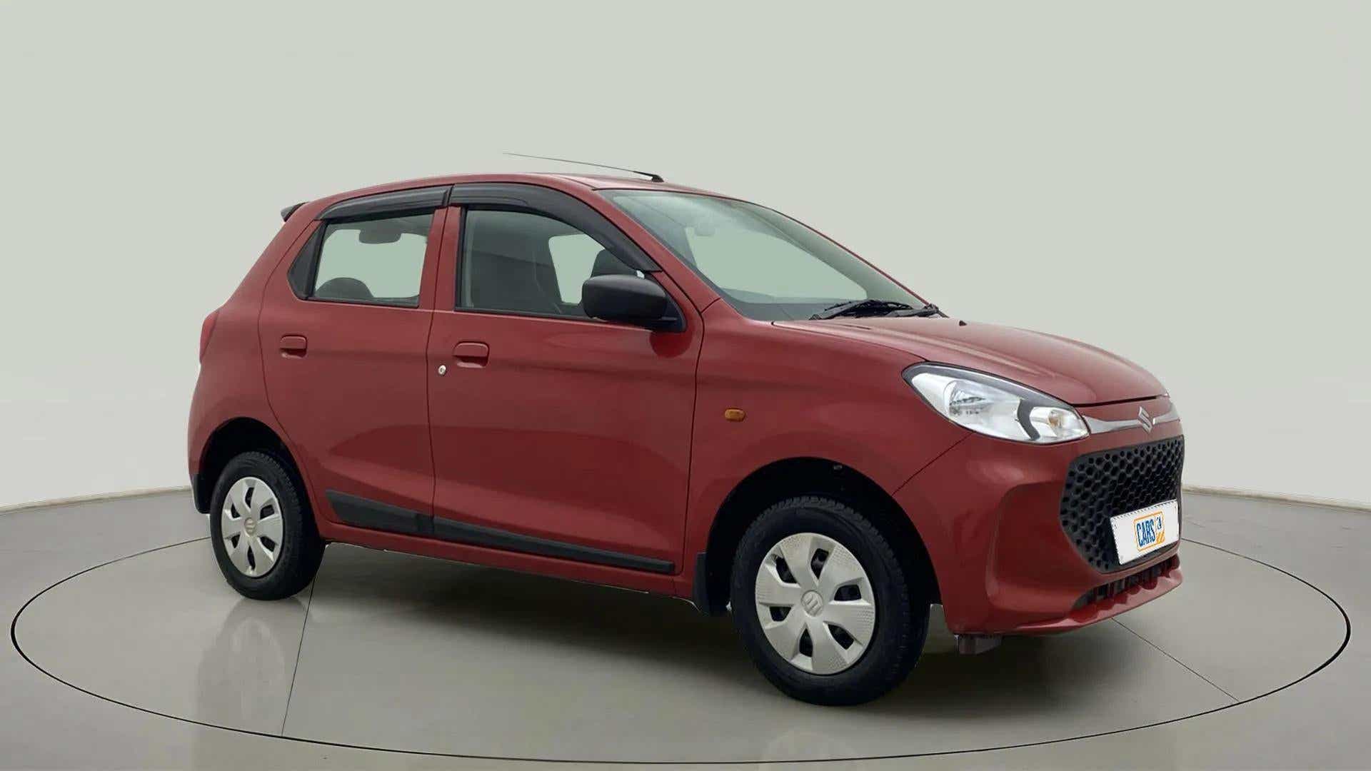 Front three-quarter view of a Metallic Sizzling Red Maruti Suzuki Alto K10