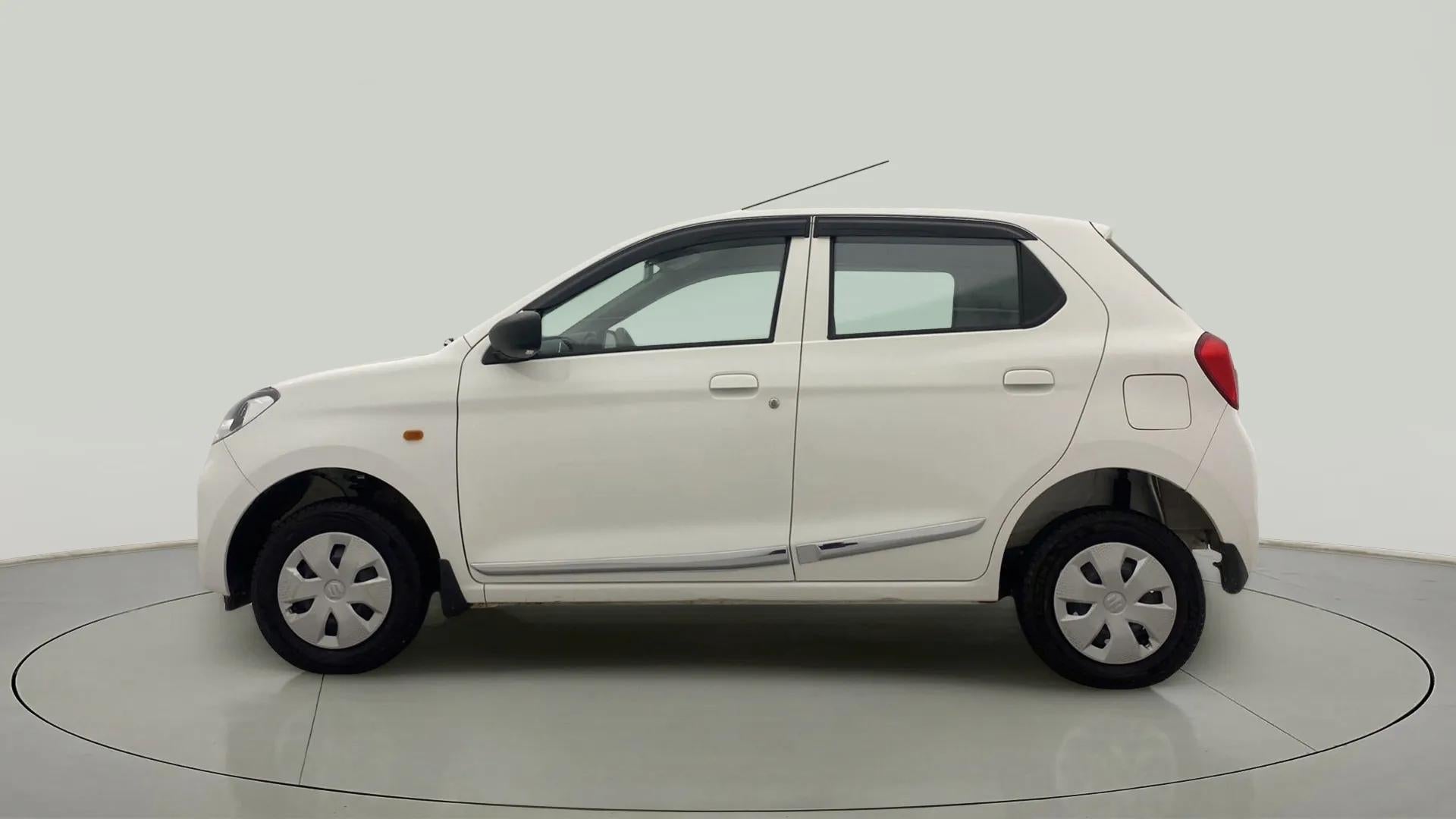 Side view of a metallic solid white Maruti Suzuki Alto K10