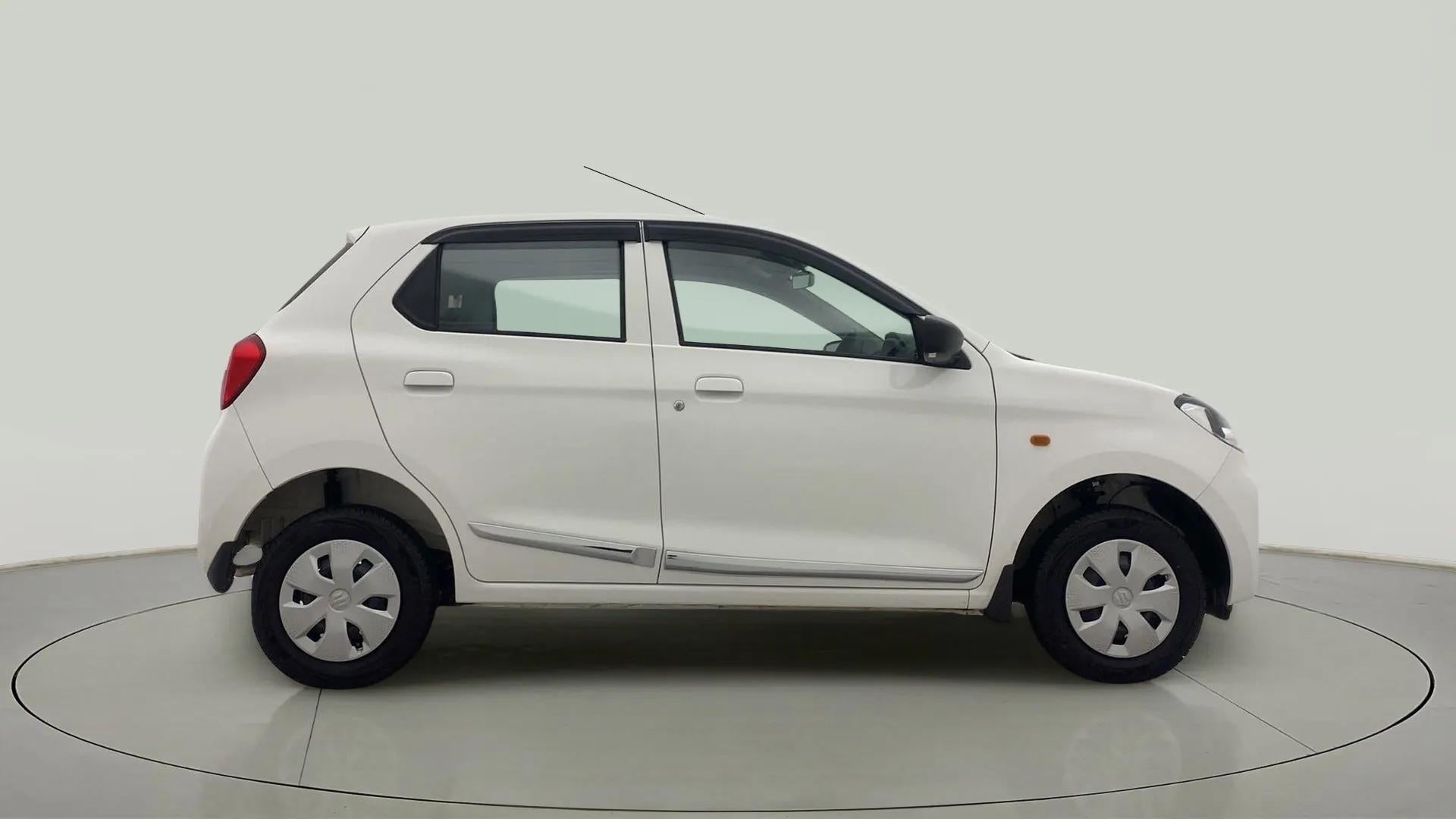 Side view of a metallic solid white Maruti Suzuki Alto K10