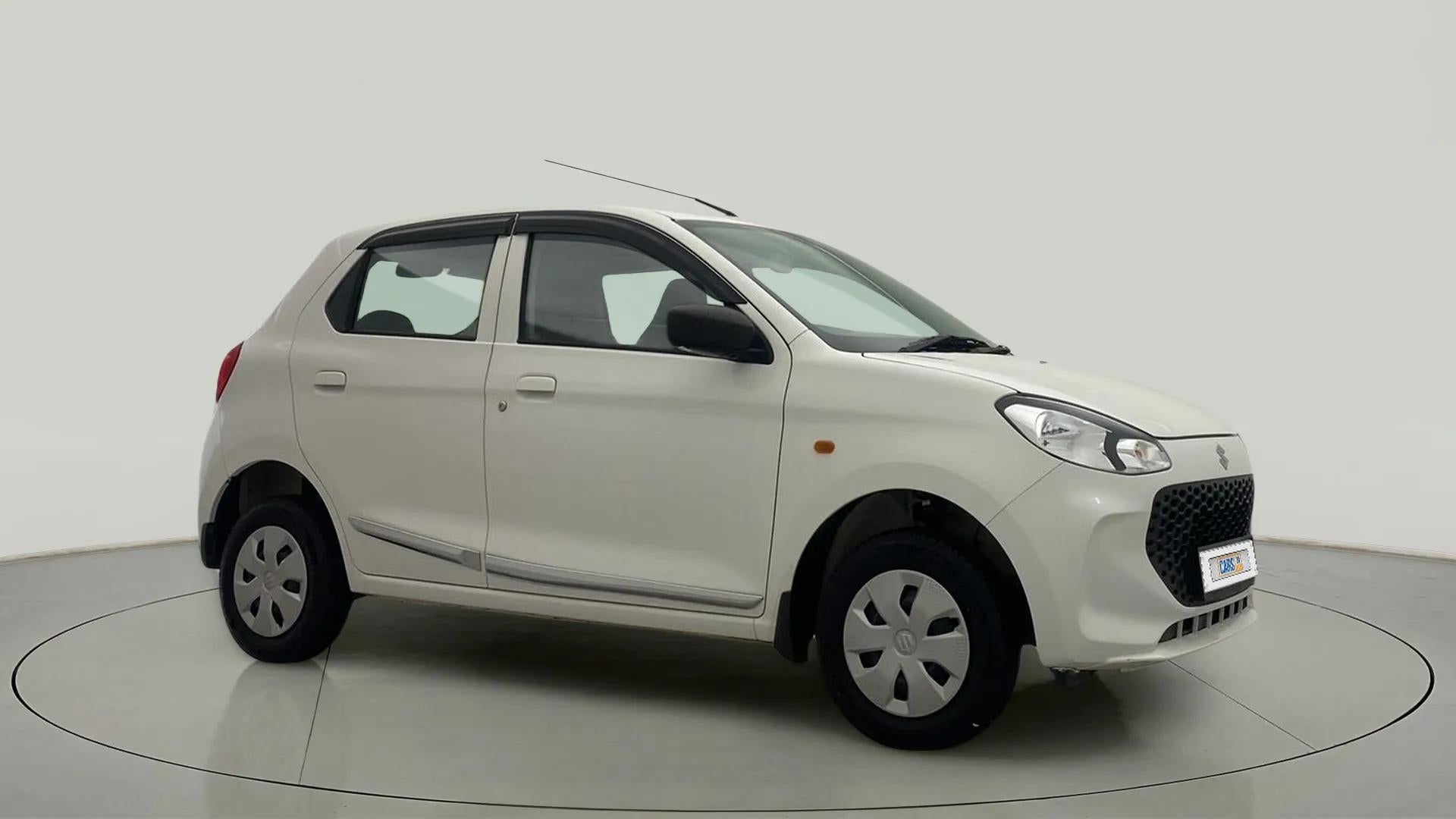 Front side view of a metallic solid white Maruti Suzuki Alto K10