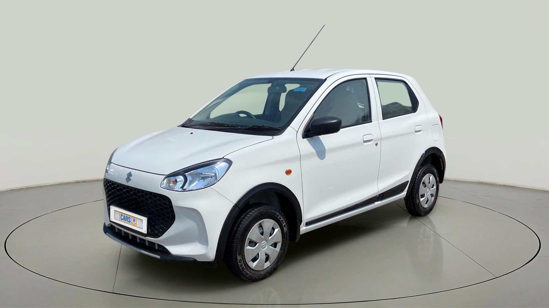 Front three-quarter view of a metallic solid white Maruti Suzuki Alto K10