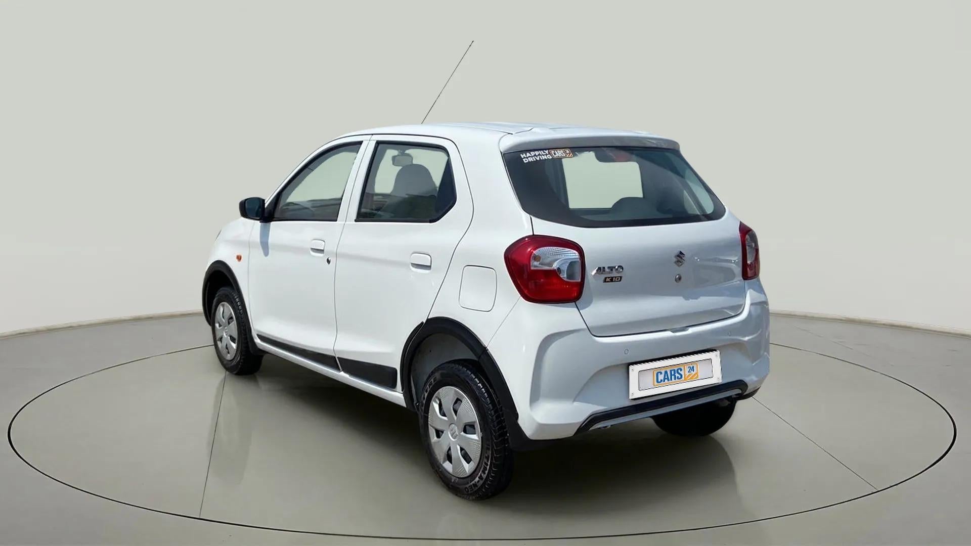 Rear three-quarter of a metallic solid white Maruti Suzuki Alto K10