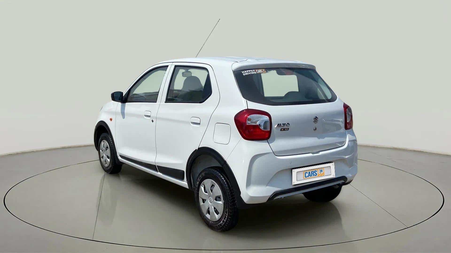 Rear three-quarter of a metallic solid white Maruti Suzuki Alto K10
