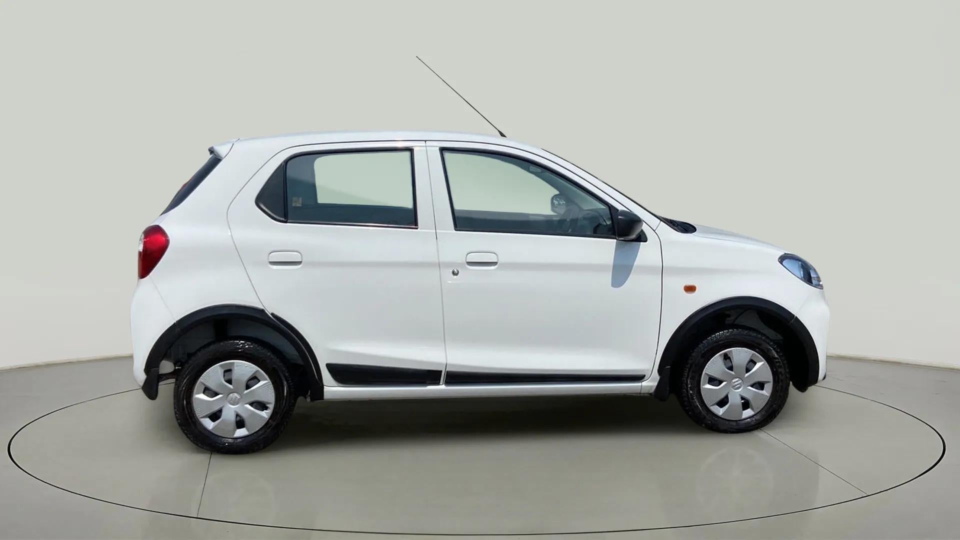 Side view of a metallic solid white Maruti Suzuki Alto K10