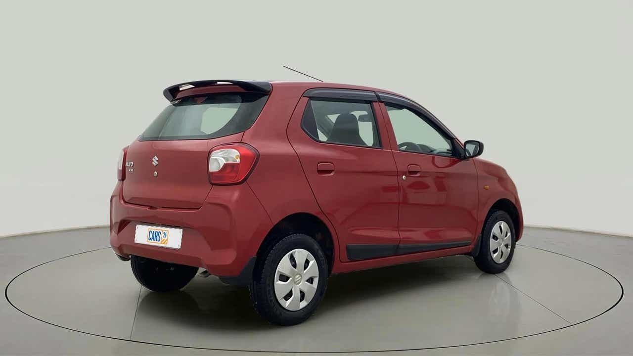Rear three-quarter view of a metallic-sizzling-red Maruti Suzuki Alto K10