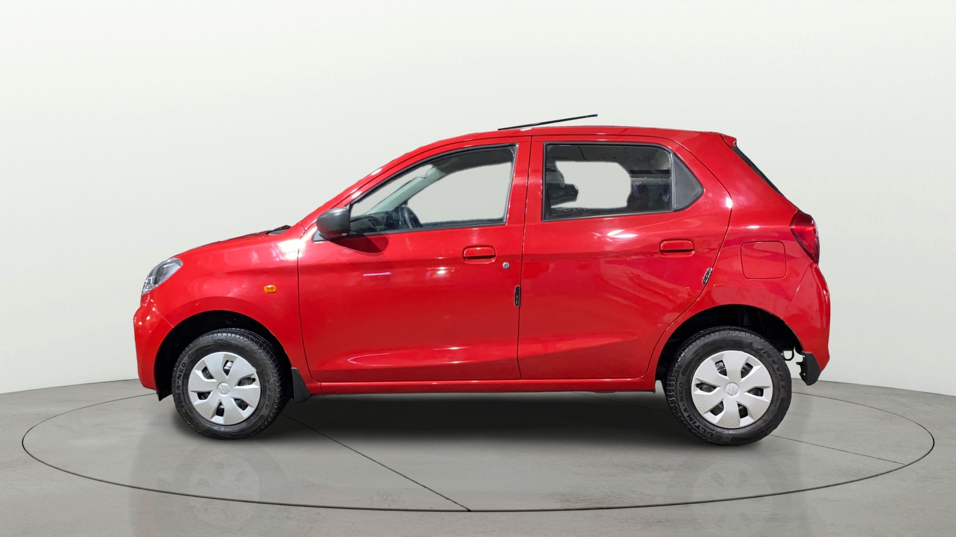 Side view of a Metallic Sizzling Red Maruti Suzuki Alto K10
