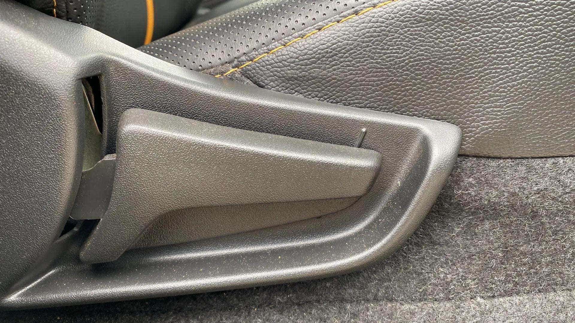 Close-up of a seat adjustment lever of a Maruti Suzuki Alto K10