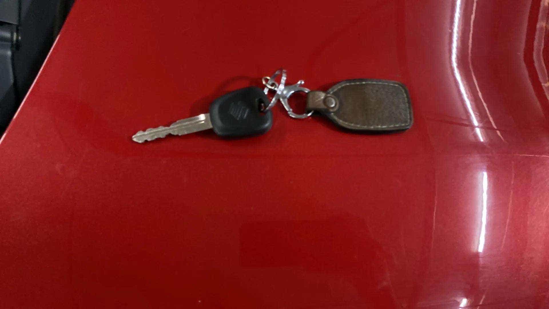 Close-up of a Maruti Suzuki Alto K10 car key on a car.